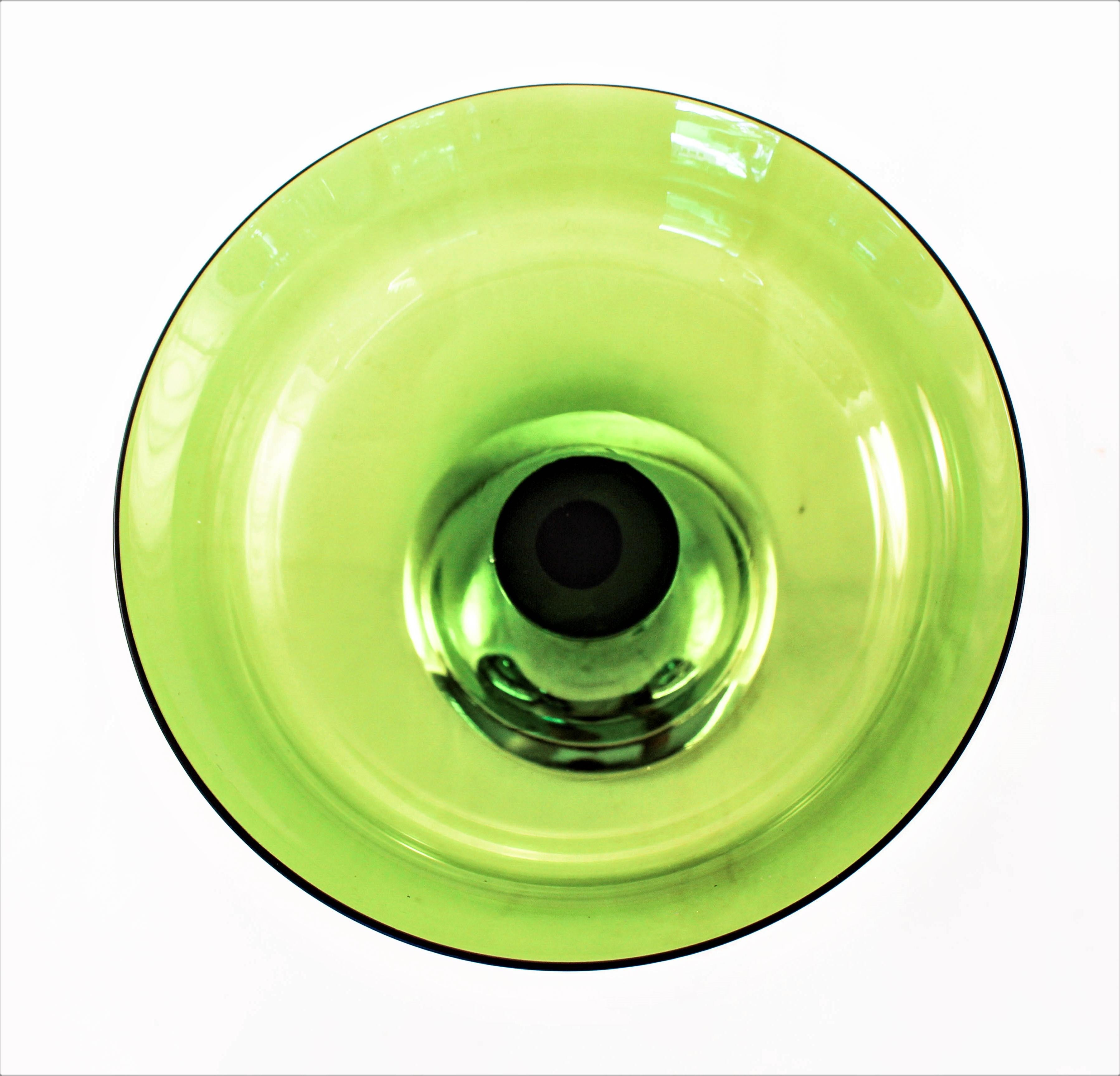 If you are like me, you love color strong vibrant colors. Colors that give your room and home style and an individuality that is distinctively your own. This compote has a sterling base and a crystal top. The color of the crystal, green is what
