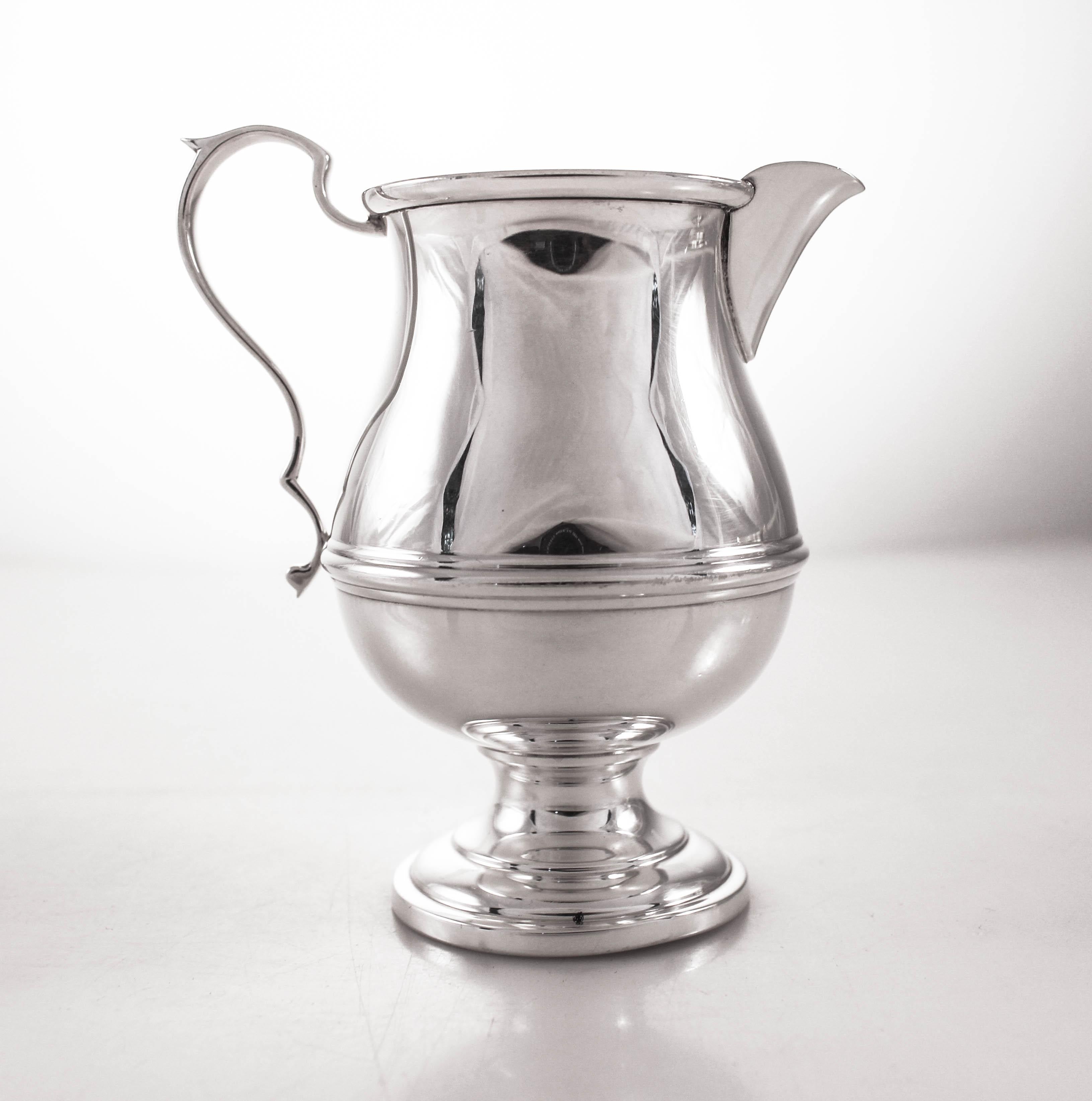 We are delighted to offer this sterling silver cream and sugar bowl set by Redlich & Co, NY. A classic design that works in any decor; just a ribbing design across the waist. Beautiful and practical this set can be used day-to-day or when hosting