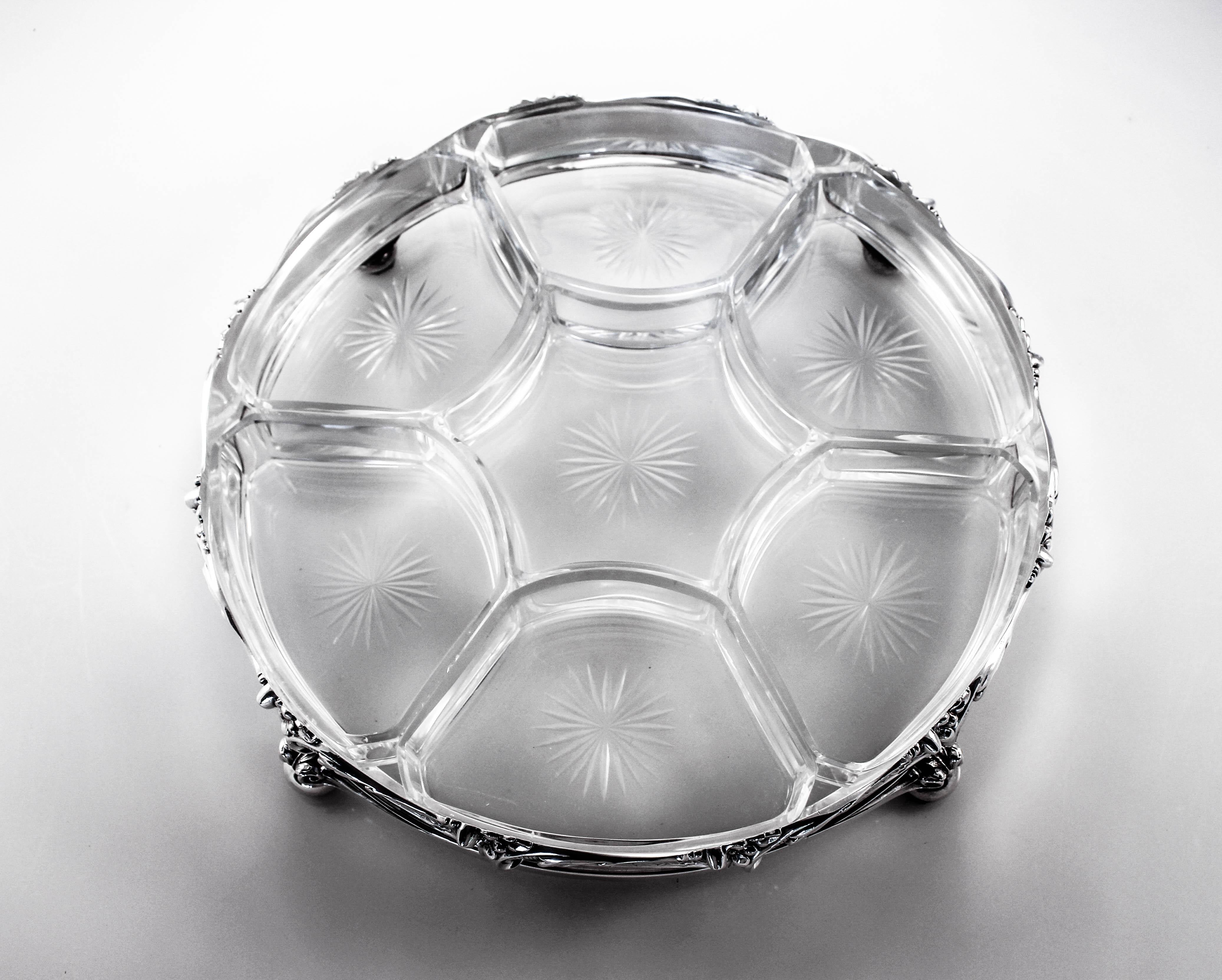 We are most delighted to offer this sterling silver and crystal sectional. Truly a one-of-kind piece! We have never seen nor had anything on this scale like it before. A series of seven crystal bowls interlock like a jigsaw puzzle to create this