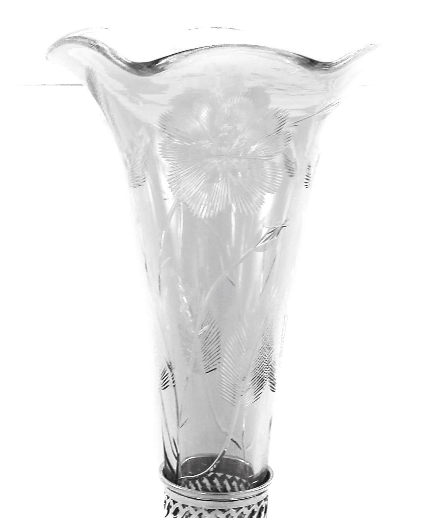 Being offered is a sterling silver and crystal vase by Frank Whiting Company of Massachusetts. This sterling base has a latticework design which was very popular in the 1930s. The crystal liner has a scalloped rim and cut-glass motif of flowers and