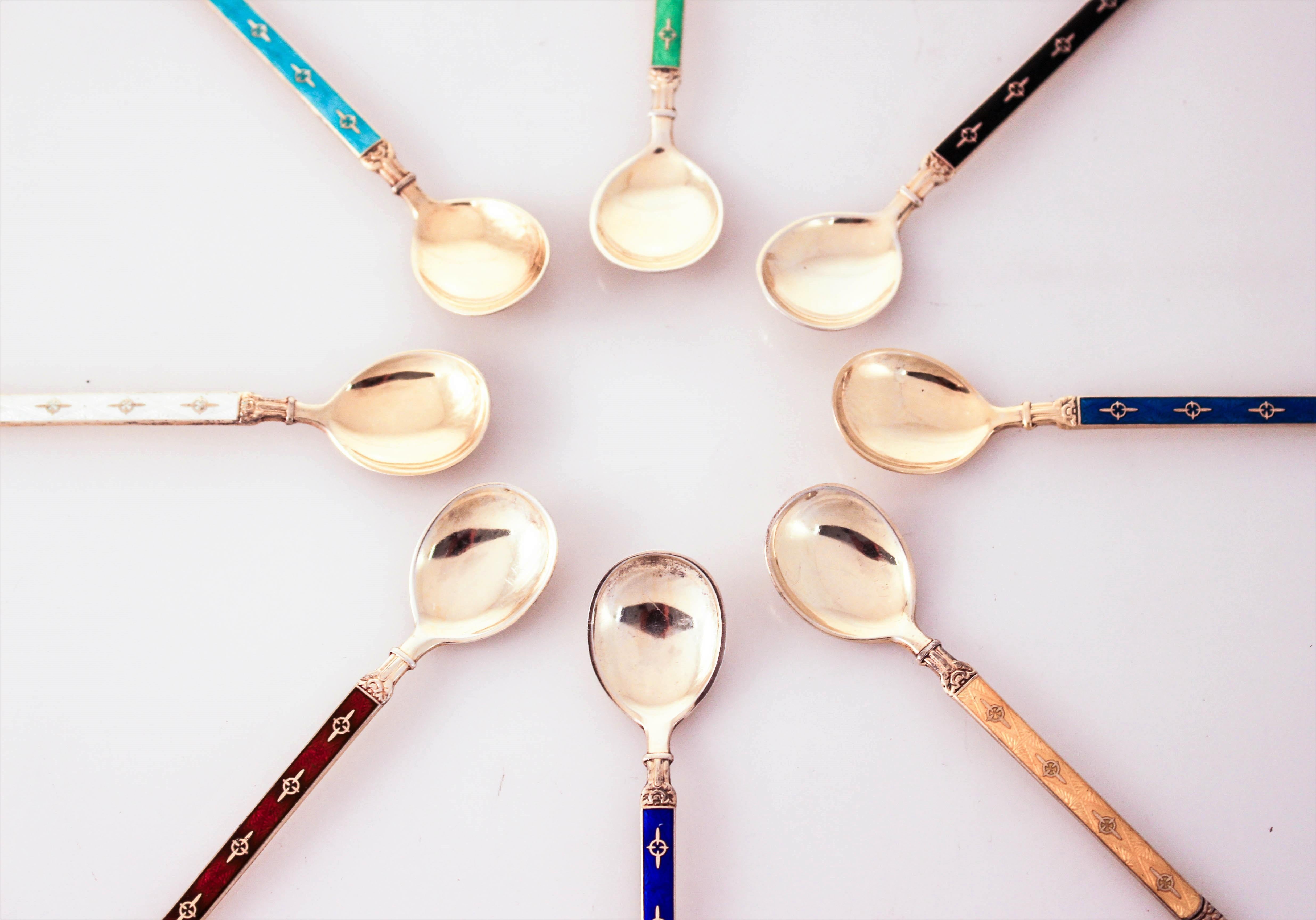 Proudly offering a set of eight sterling silver demitasse spoons. Rich vibrant colors; blue, yellow, white, green, purple, turquoise , black and maroon on gold washed sterling silver. Enamel on sterling was very popular in the Art Deco period. Each