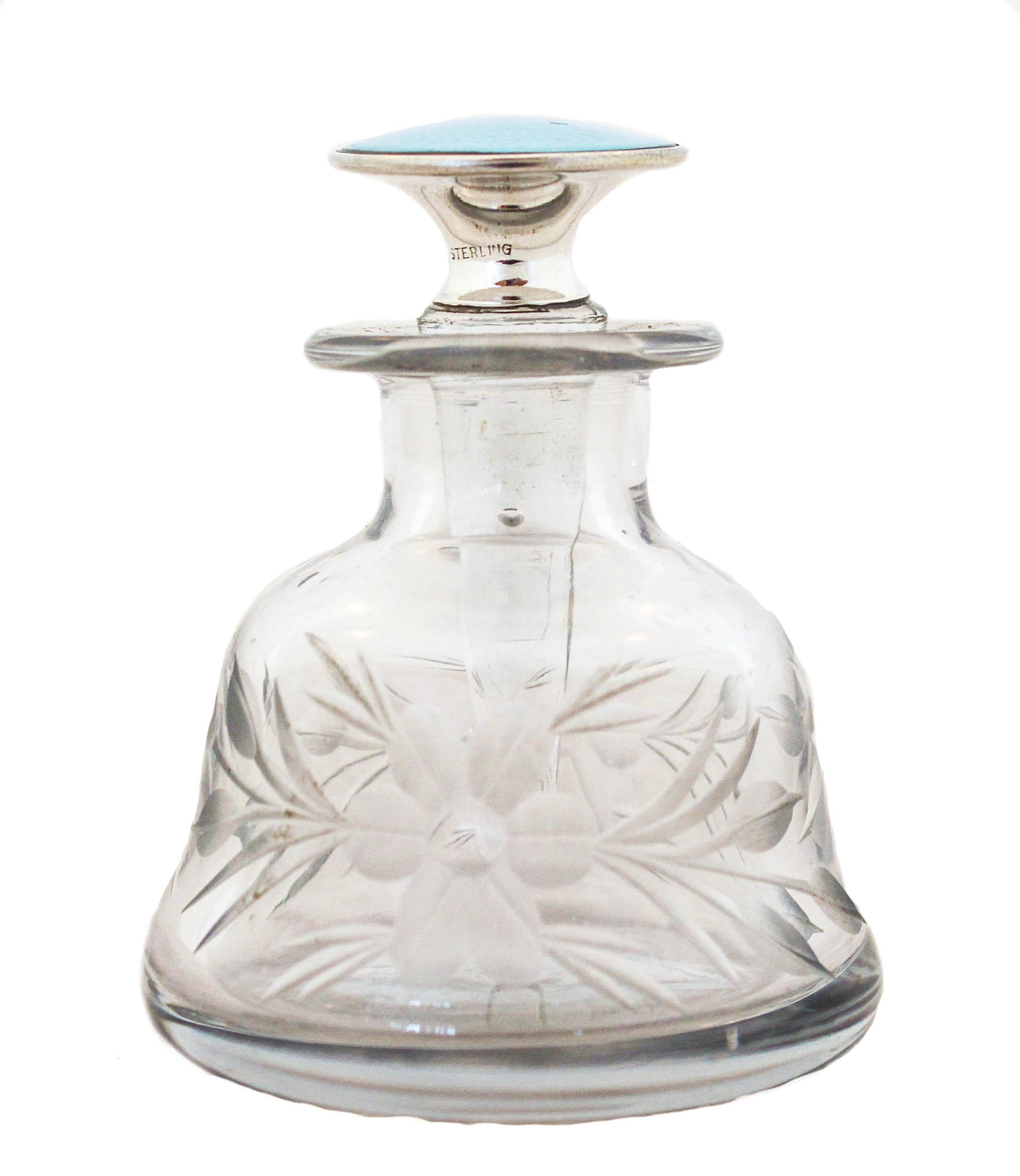 Being offered is a lovely perfume bottle by the Hawkes Glass Company. It has a sterling silver enamel stopper and crystal bottle. The glass has acid-etched flowers and leaves going around the body. The enamel is a powder blue; soft and feminine. A