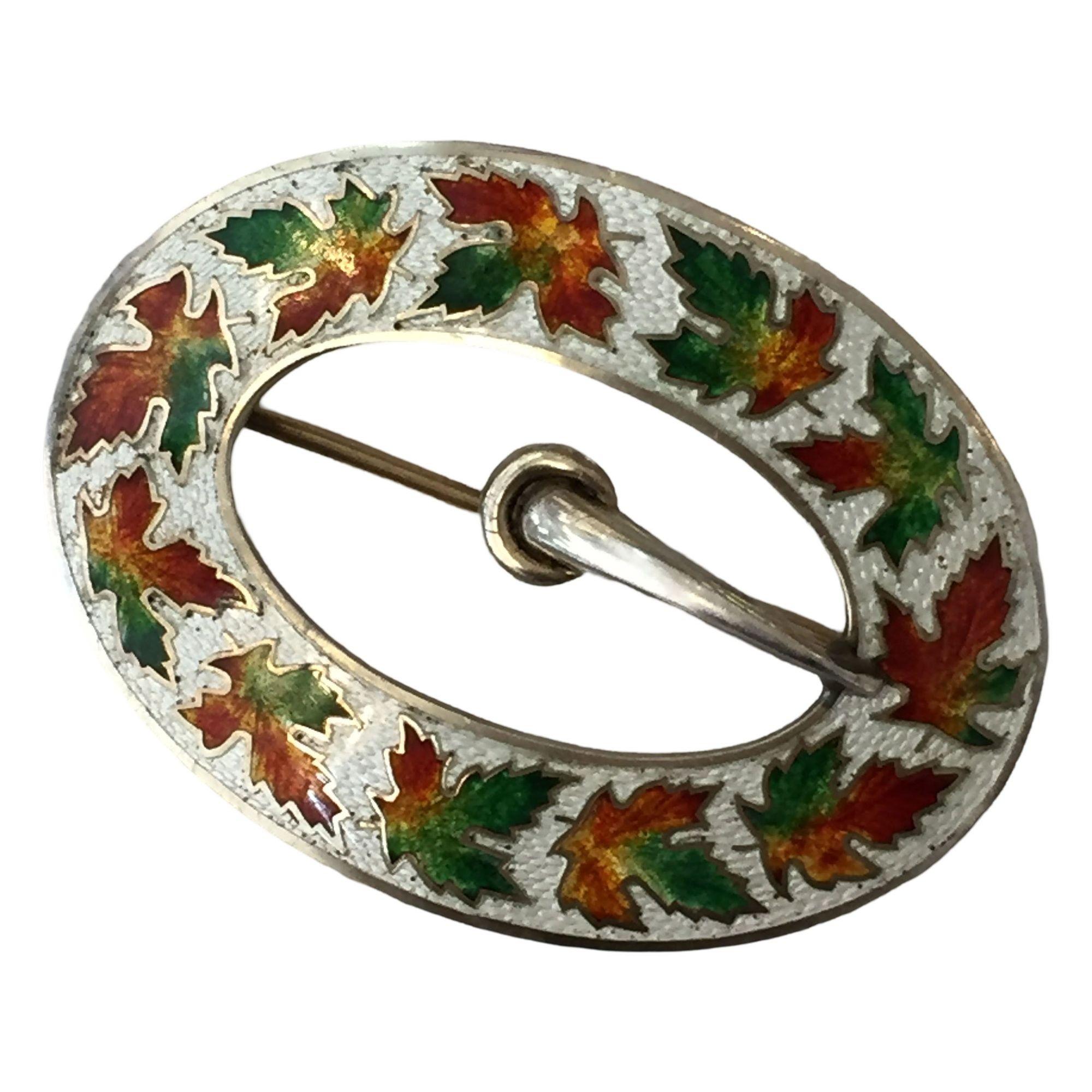 Sterling silver enamelware belt buckle brooch with pin back.
Signed with a Hallmark which reads 