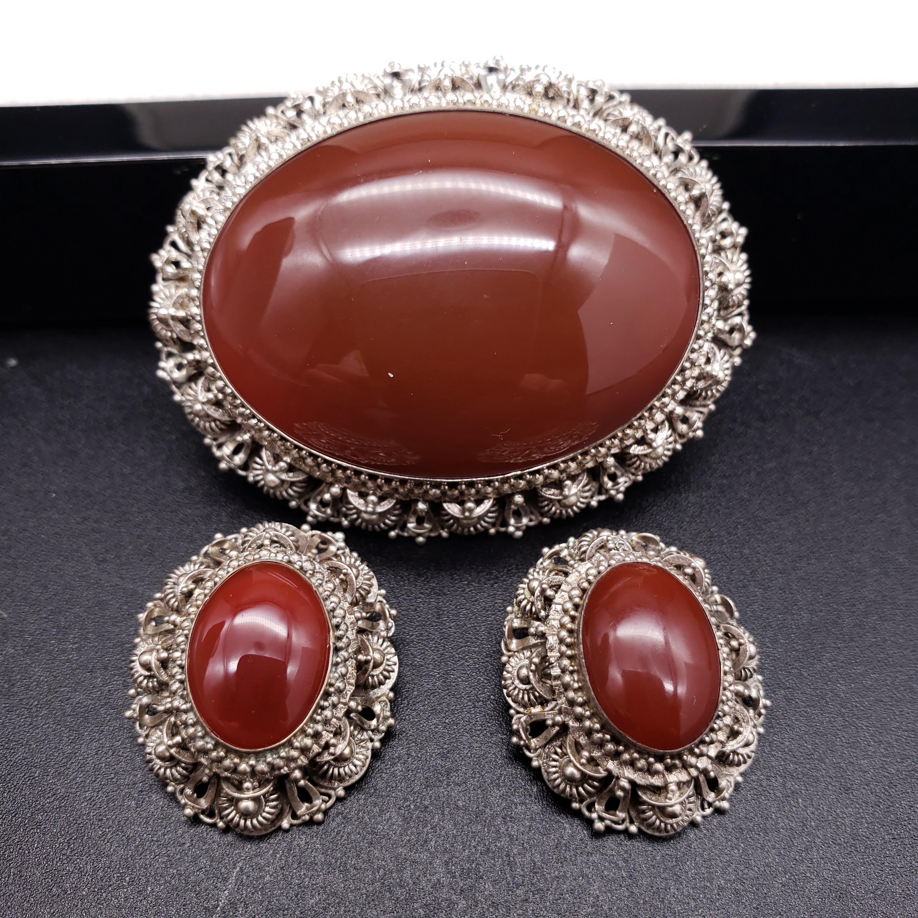 An extravagant set of clip on earrings and a brooch, decorated with carnelian in a sterling silver filigree setting. 
Lavish Victorian set is sure to impress!

From vintage stock in excellent condition

Brooch dimensions: 2 1/4 x 1 3/4