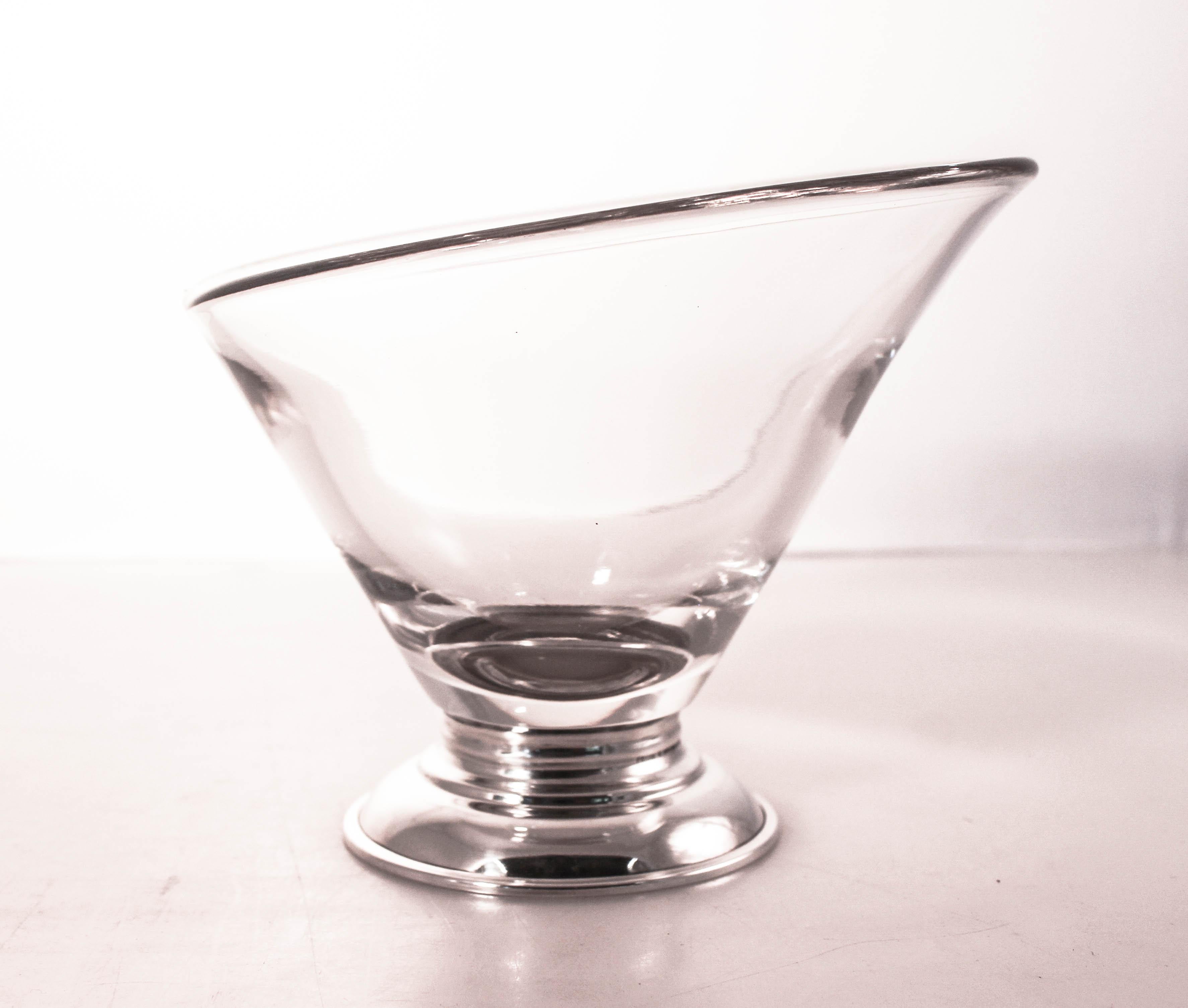 We are thrilled to offer this pair of sterling silver and glass cocktail bowls. A great add-on to your bar; they are not only attractive but practical. The perfect size for olives, lemons or nuts. They have a super modern shape with one side lower