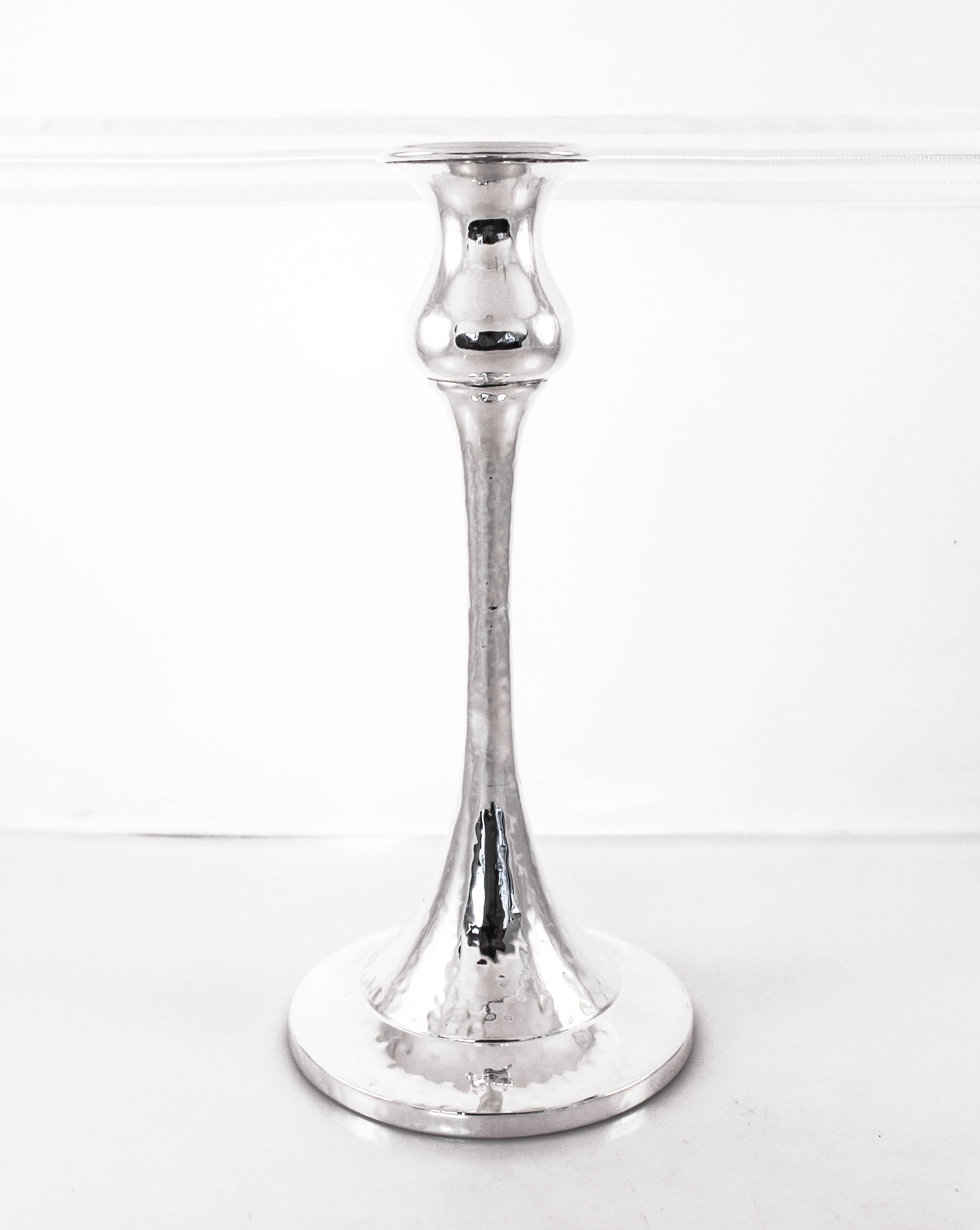 A pair of hammered sterling silver candlesticks that have a young and modern feel. They are regal and beautiful; any bride will be proud to use them.