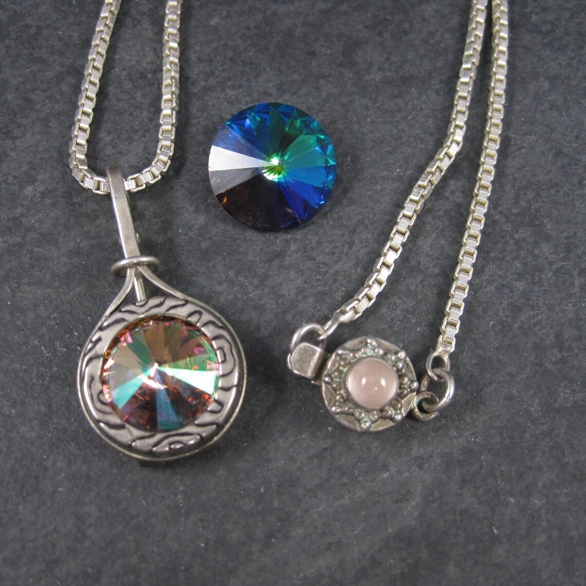 This gorgeous vintage pendant is sterling silver.
It features a 