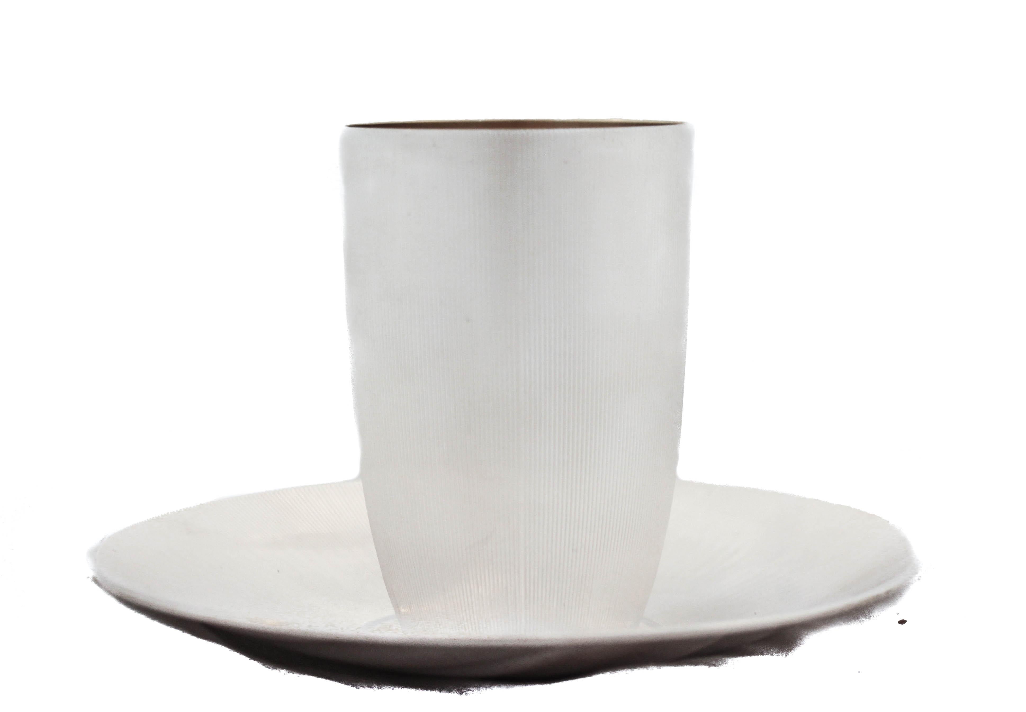 This sterling silver cup and plate are made in Jerusalem, Israel. The set is very handsome and masculine with its pinstripe design. The cup has a modern shape and the plate compliments the curvature with the sides curving upwards. A beautiful