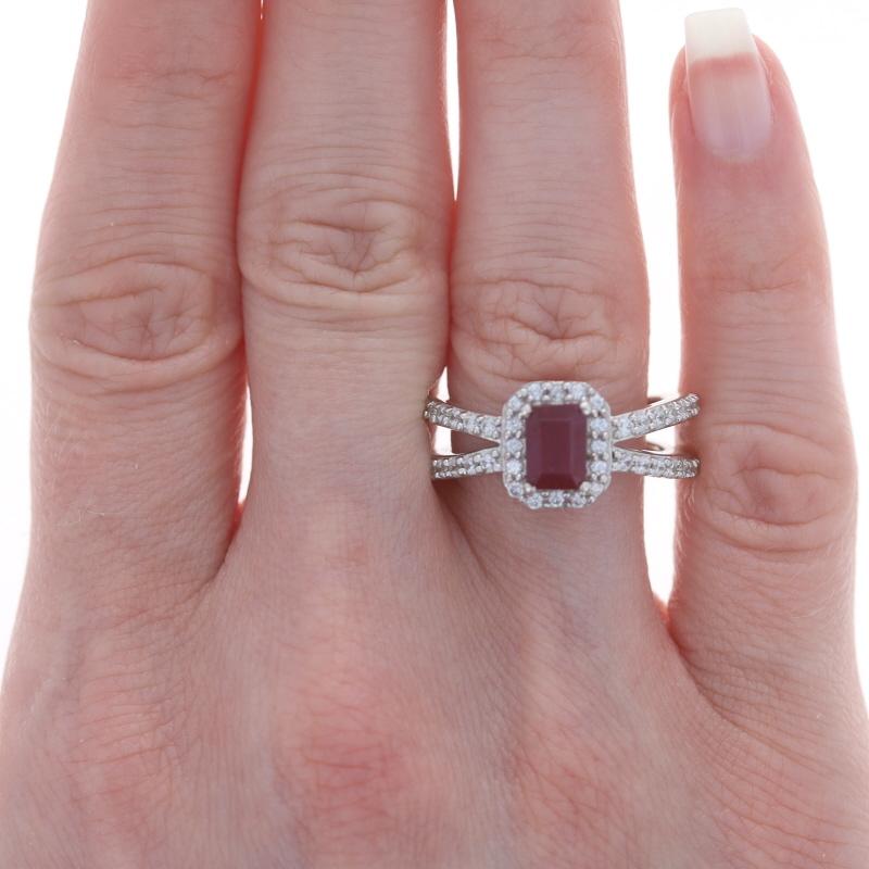 Sterling Lead Glass Filled Ruby & White Sapphire Halo Ring 925 Emerald Cut

Stone Information:
Natural Ruby
Treatments: Heated & Lead Glass Filled
Cut: Emerald
Color: Pinkish Red

Natural White Sapphires
Cut: Round

Additional Information: