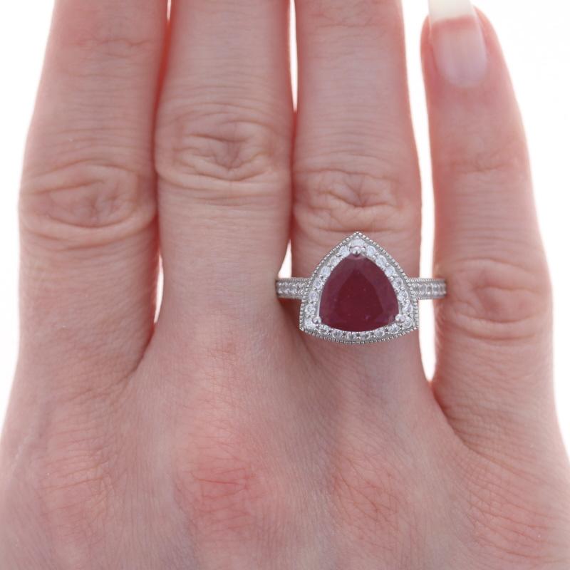 Sterling Lead Glass Filled Ruby White Sapphire Halo Ring 925 Trillion Engagement

Stone Information:
Natural Ruby
Treatments: Heated & Lead Glass Filled
Cut: Trillion
Color: Red

Natural White Sapphires
Treatment: Heating
Cut: Round

Additional