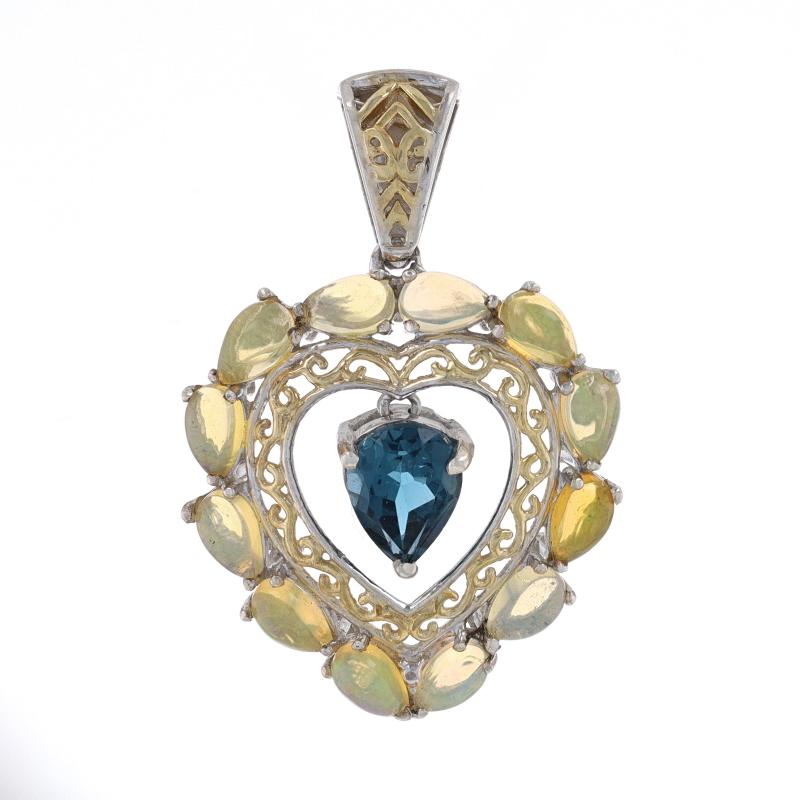 Metal Content: Sterling Silver (gold plated)

Stone Information
Natural London Blue Topaz
Treatment: Routinely Enhanced

Natural Ethiopian Opals

Style: Dangle Halo
Theme: Heart, Love
Features: Open Cut Detailing

Measurements
Tall (from extended