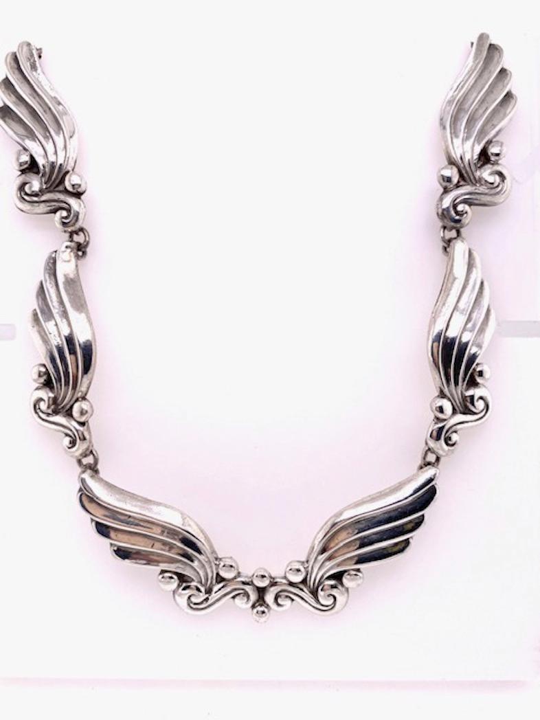 Very flattering sterling silver necklace. Made and signed by MARGOT.  Bead and leaf design.  15