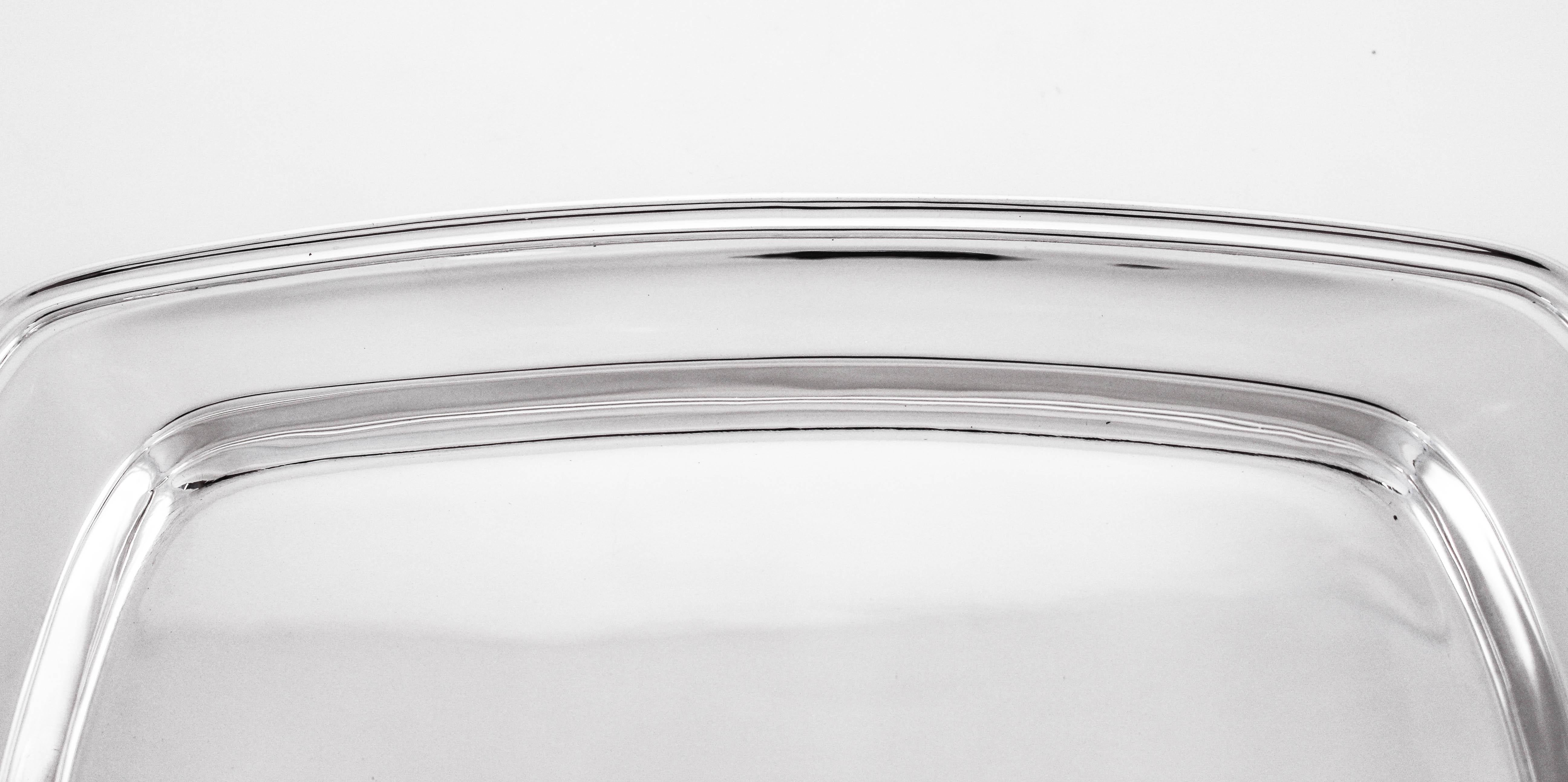 This oblong sterling silver tray by Towle Silversmiths is designed in the Mary Chilton pattern. It has a simple tailored look; no etching or decoration. A clean and modern feel. Perfect for mail, perfume bottles or even for desserts.