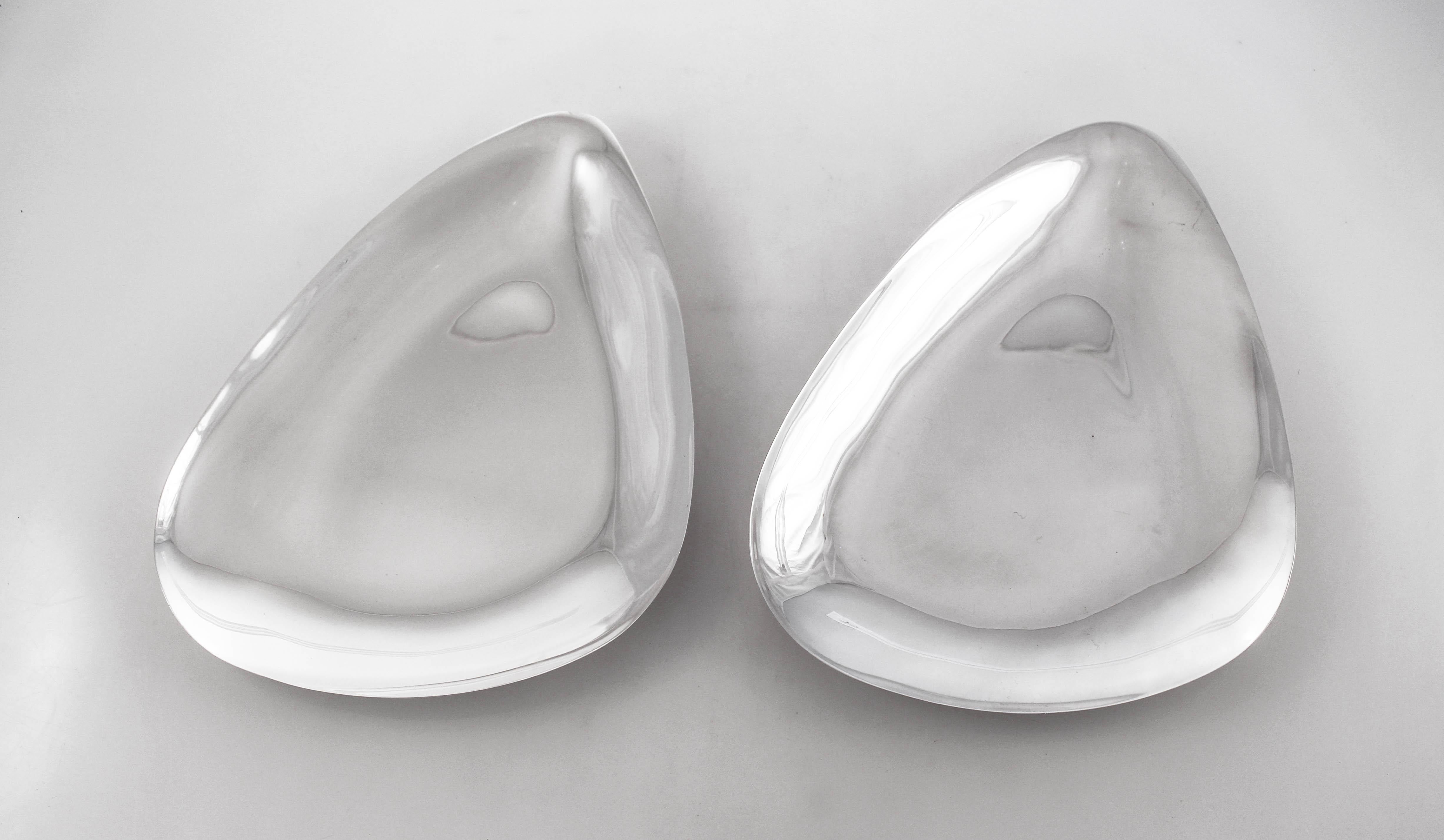 An incredible pair of sterling silver midcentury dishes by Reed and Barton. This pair is sure to wow you and your guests. Abstract but with a triangular shape, they are sleek and uber-modern. No etchings or designs, they have a smooth and clean look