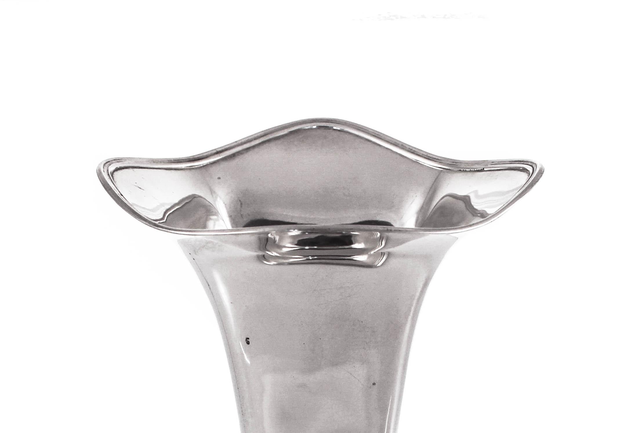 Handsome, modern and tailored are just some of the adjectives one can use in describing this sterling silver vase. In keeping with the midcentury theme of less is more, this piece has no etchings or designs. It has a square shaped base and is