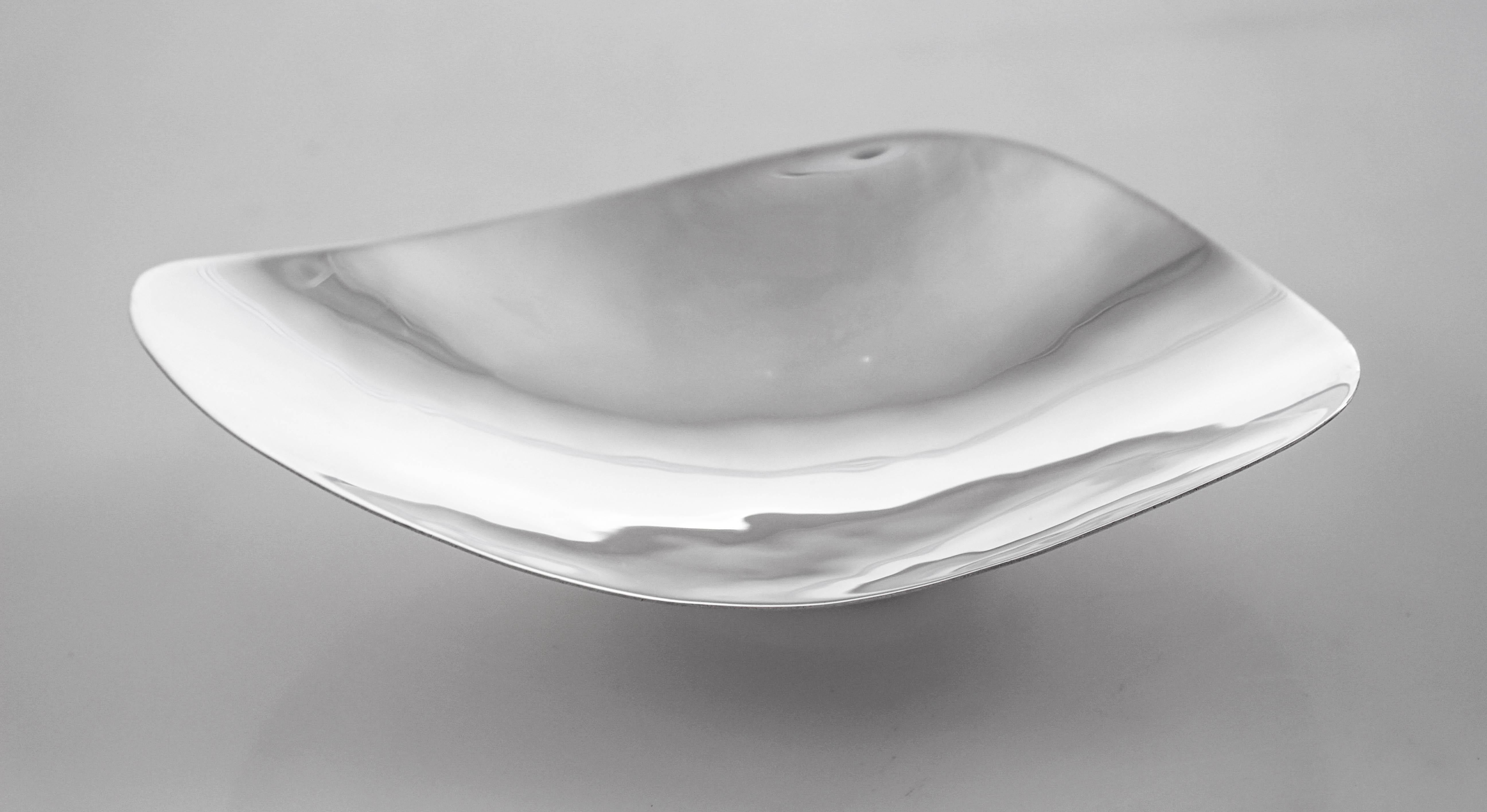 Modernism is all the rage and here’s a lovely example; this sterling silver candy dish. Shaped like an abstract triangle, it stands on a pedestal (not weighted). The ends are fluted; they tilt upwards whereas the center is a bit lower. A great