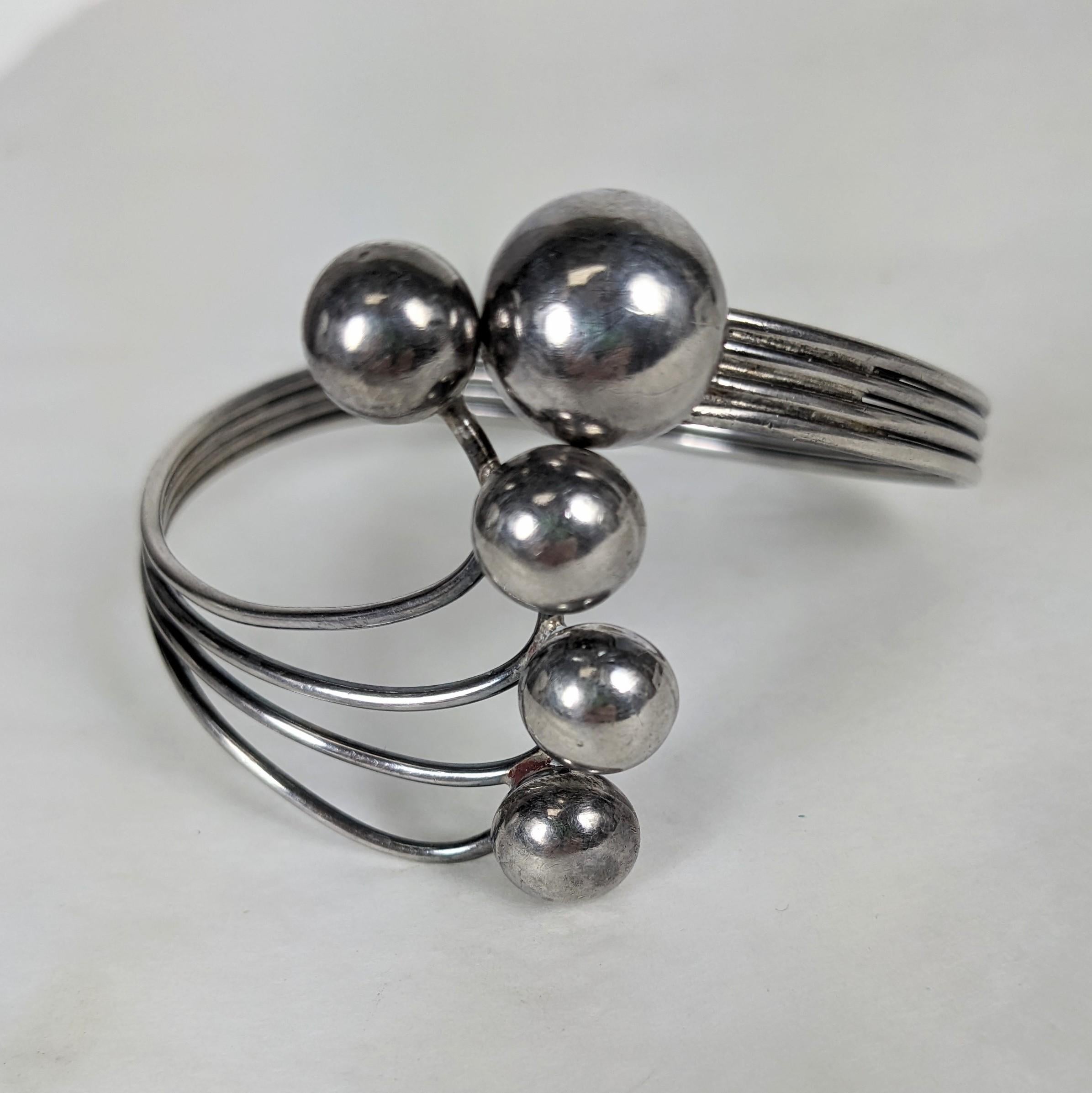 Sterling Modernist Clamper from the 1940's. Handmade with 4 wires and handmade ball motifs. The largest ball clamps around the arc of the other 4. Measures 2