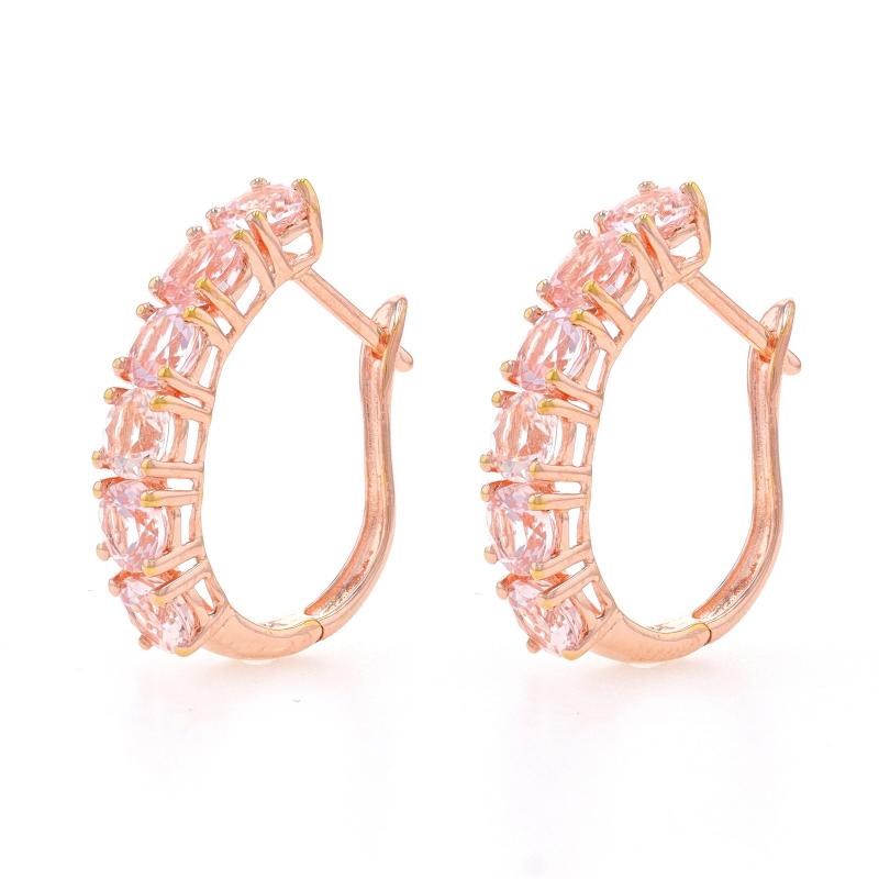 Metal Content: Sterling Silver (rose gold plated)

Stone Information

Natural Morganites
Carat(s): 3.00ctw
Cut: Round
Color: Light Pink

Total Carats: 3.00ctw

Style: Six-Stone J- Hoop
Fastening Type: Snap Closures

Measurements

Tall: 13/16