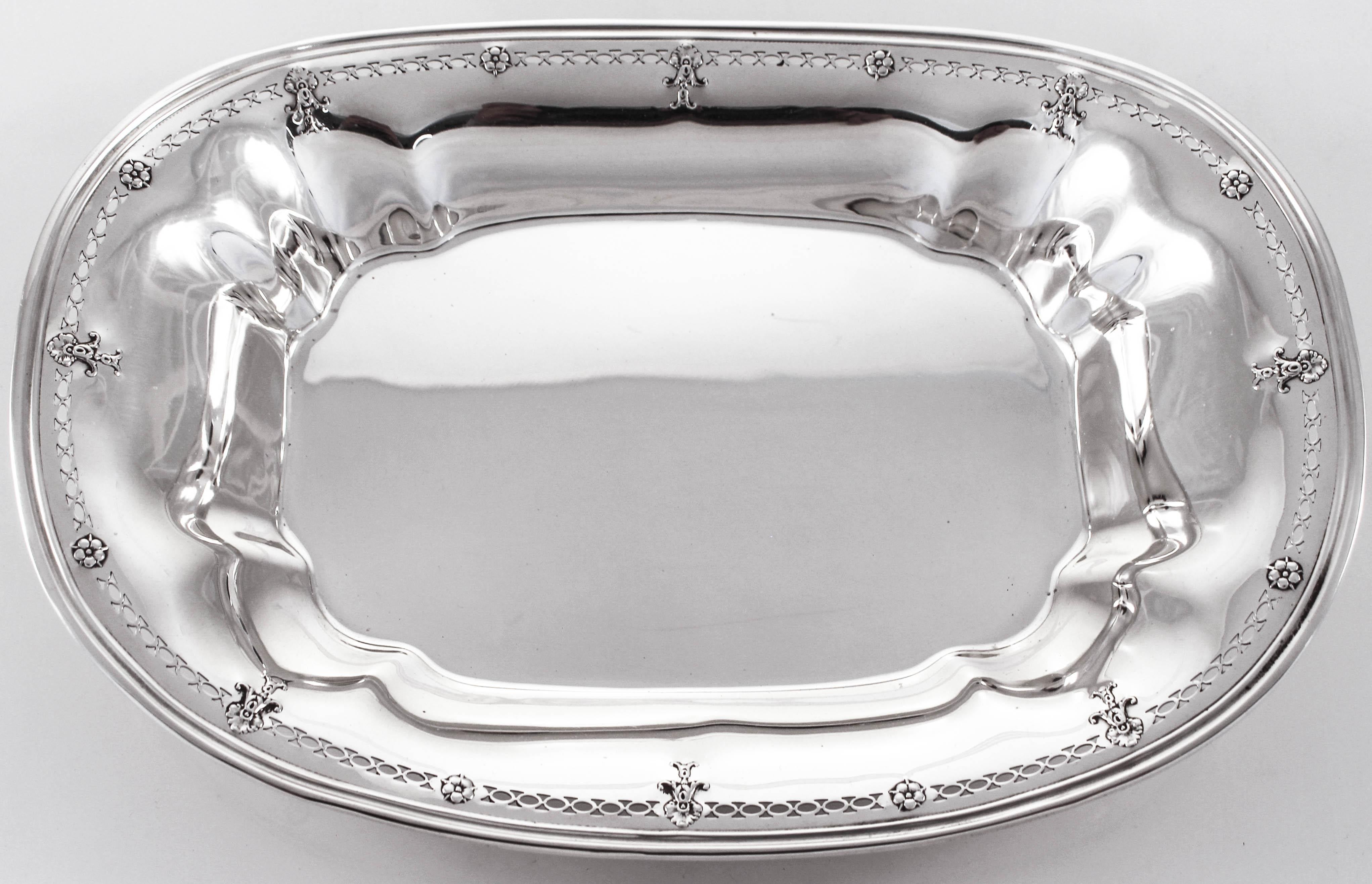 We are delighted to offer this lovely sterling silver dish by Reed & Barton. Oblong in shape with just a hint of detail around the edge, this piece promises to delight everyone’s taste. There is an open-work pattern circling the rim with flowers