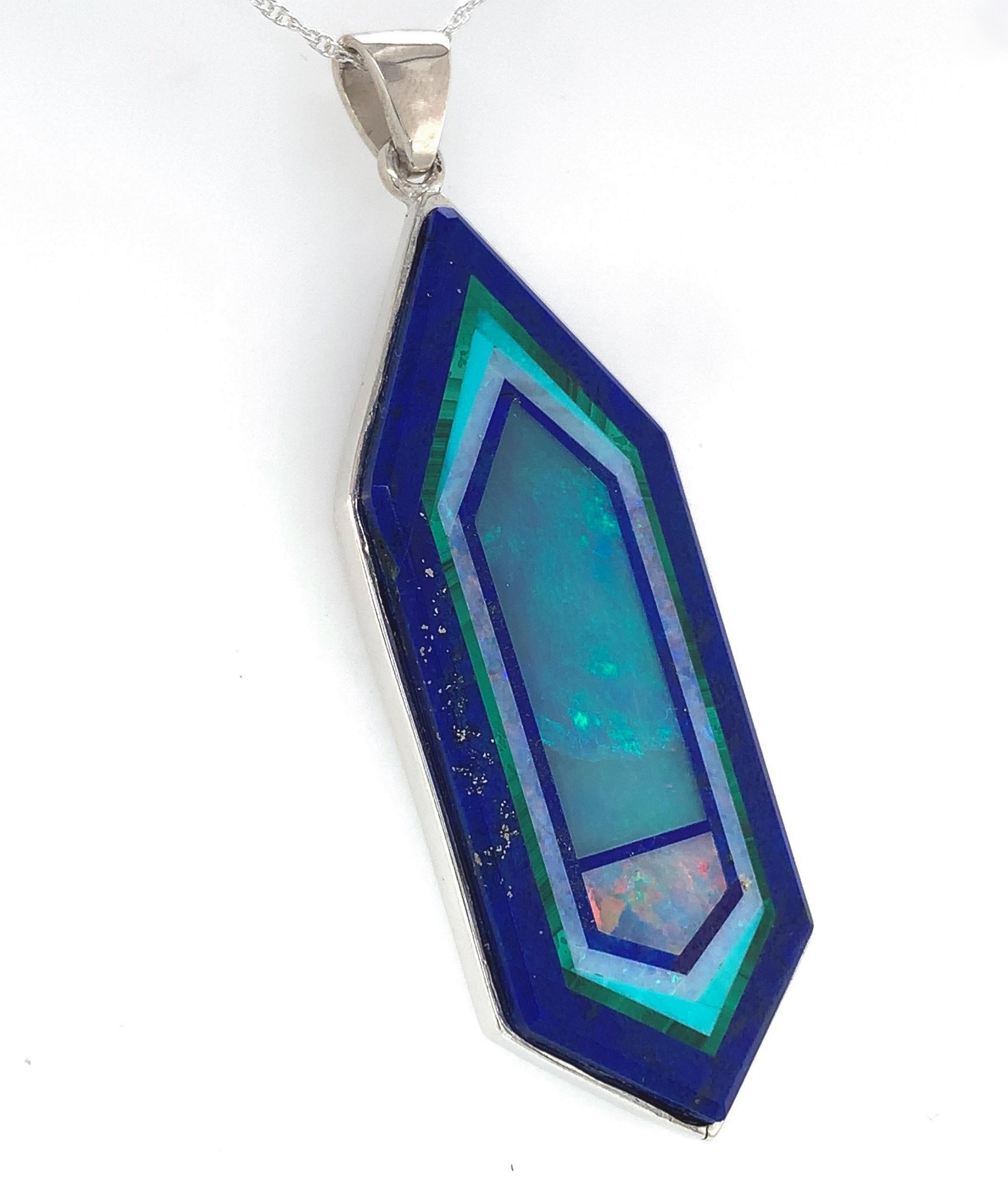 Sterling large opal Intarsia pendant.  The gemstone is made with lapis inlaid with opal, malachite, turquoise and a lapis inner frame.  The intarsia was made and is signed by Jim Kaufmann. It has a custom sterling bezel.  The large intarsia stone