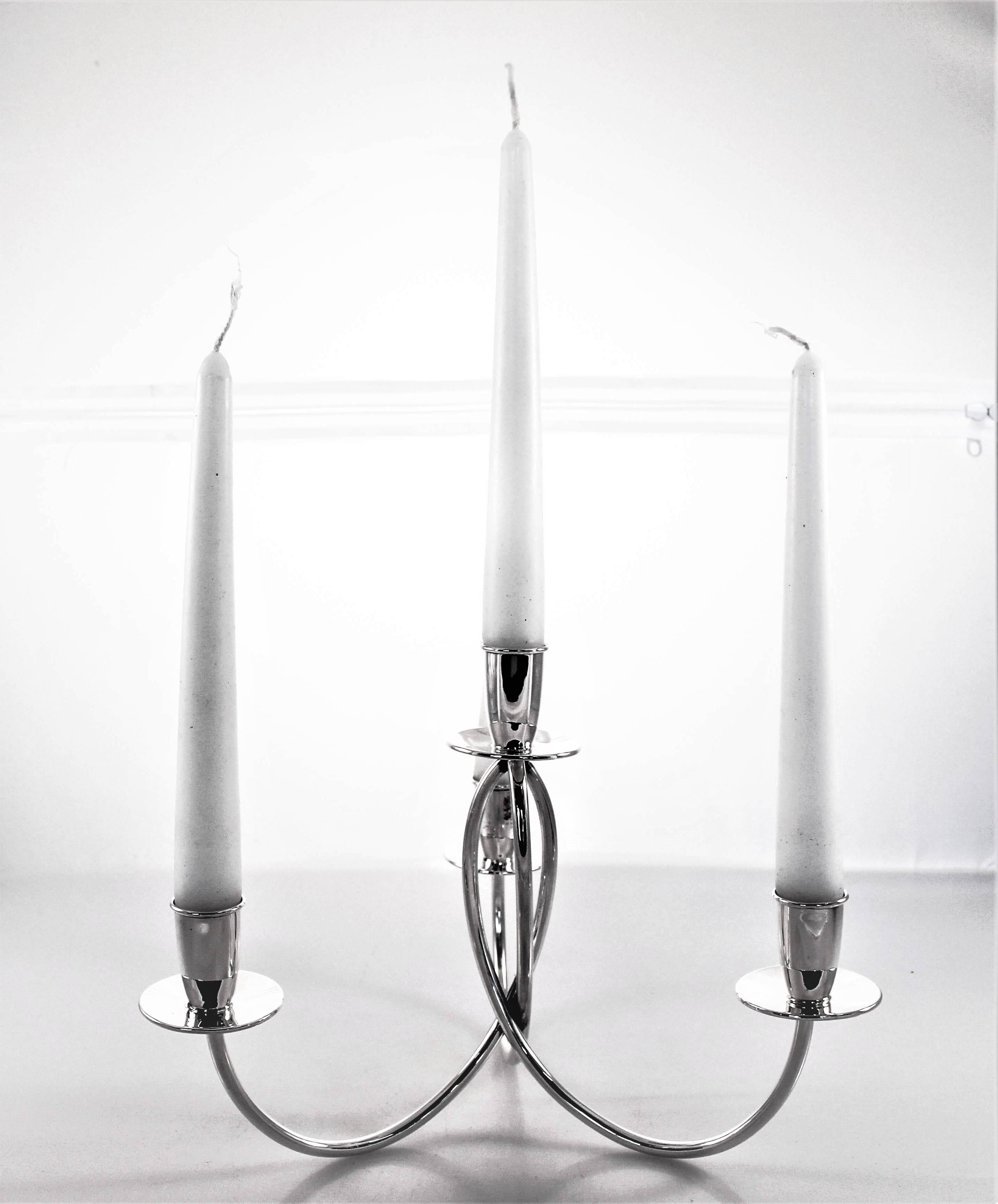 Proudly offering this pair of Mid-Century Modern candelabras. They have a chic and understated look to them. The arms and bobeches are unadorned; just a simple twist in the centre gives them all the design they need. Midcentury is all about