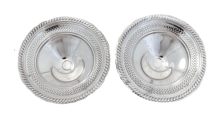 Being offered is a pair of sterling silver compotes. They have a gadroon pattern around the edge and a symmetrical cutout design just beneath. Perfect for casual entertaining, they will look gorgeous on your coffee table.