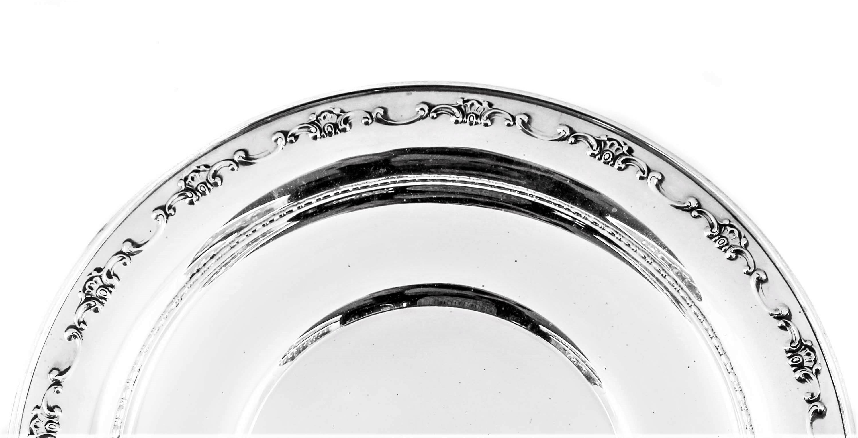 Manufactured by the Gorham Company of Rhode Island. This sterling dish has a raised, swirl-like design going around the edge. It’s a very practical size, great for sweets or baked treats.