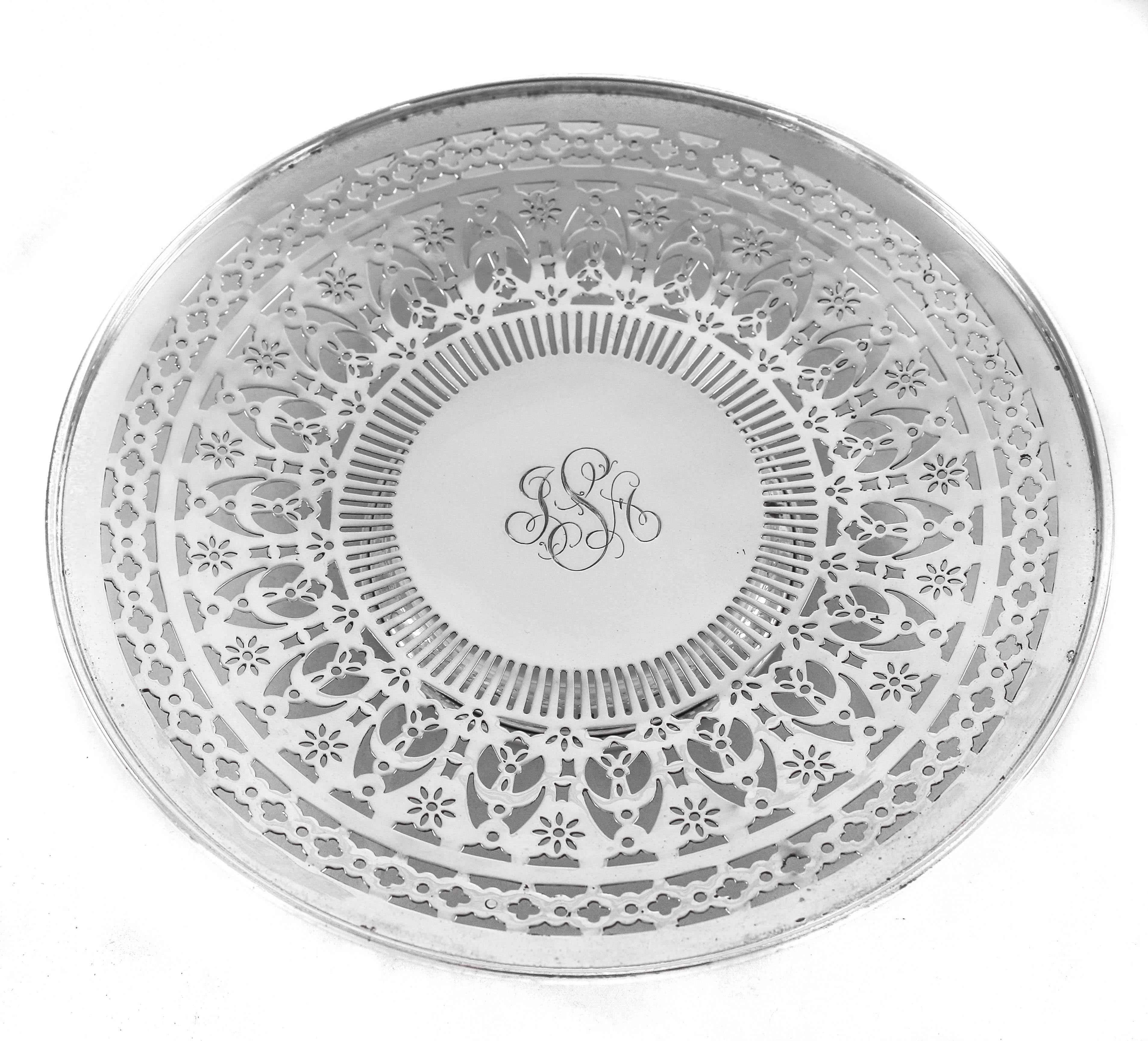 Look at the beautiful pierced work on these sterling plate; truly exceptional. It stands on a pedestal, raising it off the surface. All different patterns of cutouts come together to make this reticulated piece a sight for sore eyes.