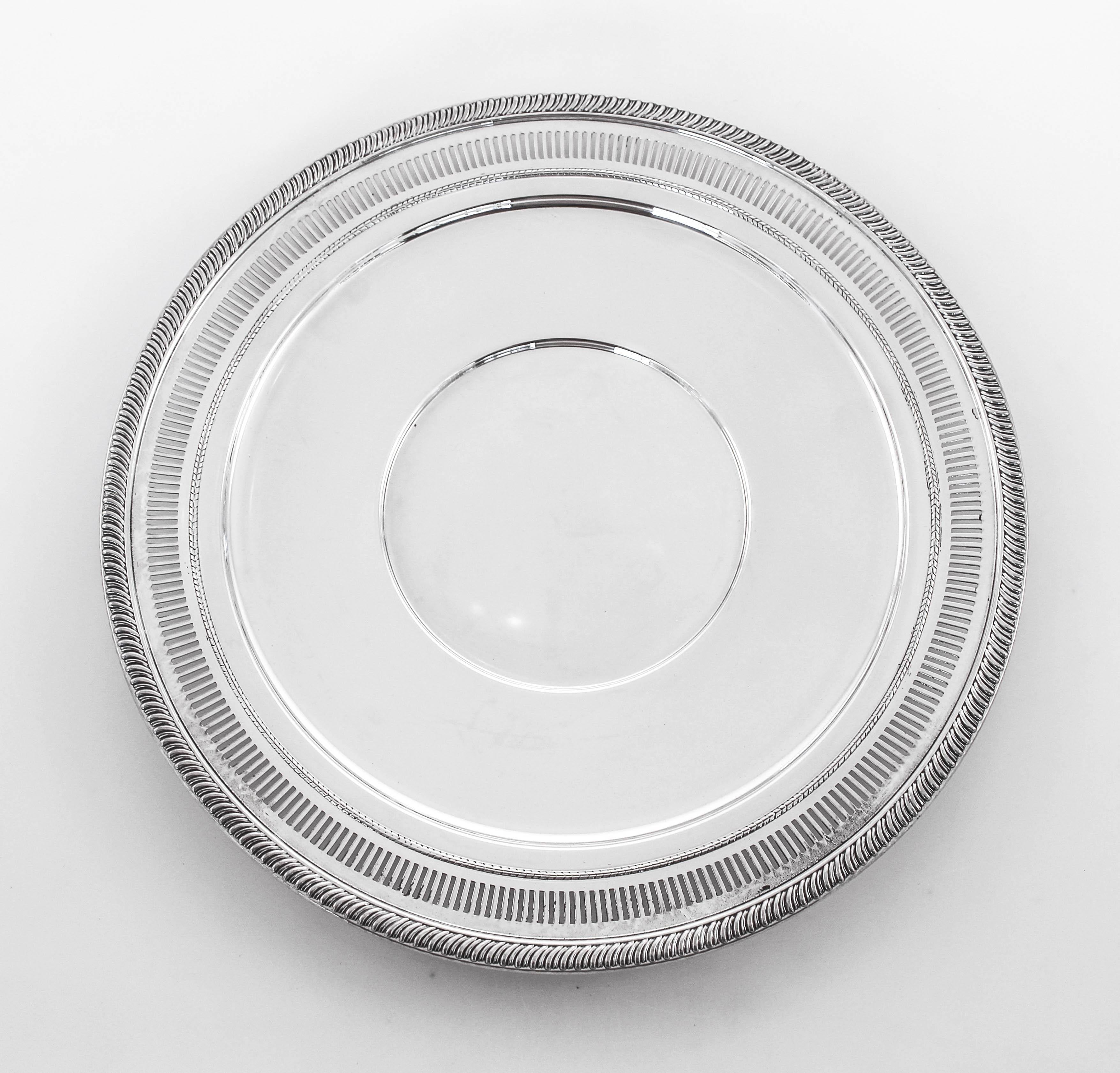 We are proud to offer this sterling silver plate made by Fisher Brothers Silver company. A gadroon design encircles the edge whilst on the inside border a series of cut-outs decorates it. It’s flat and that makes it ideal for hors d’oeuvres and