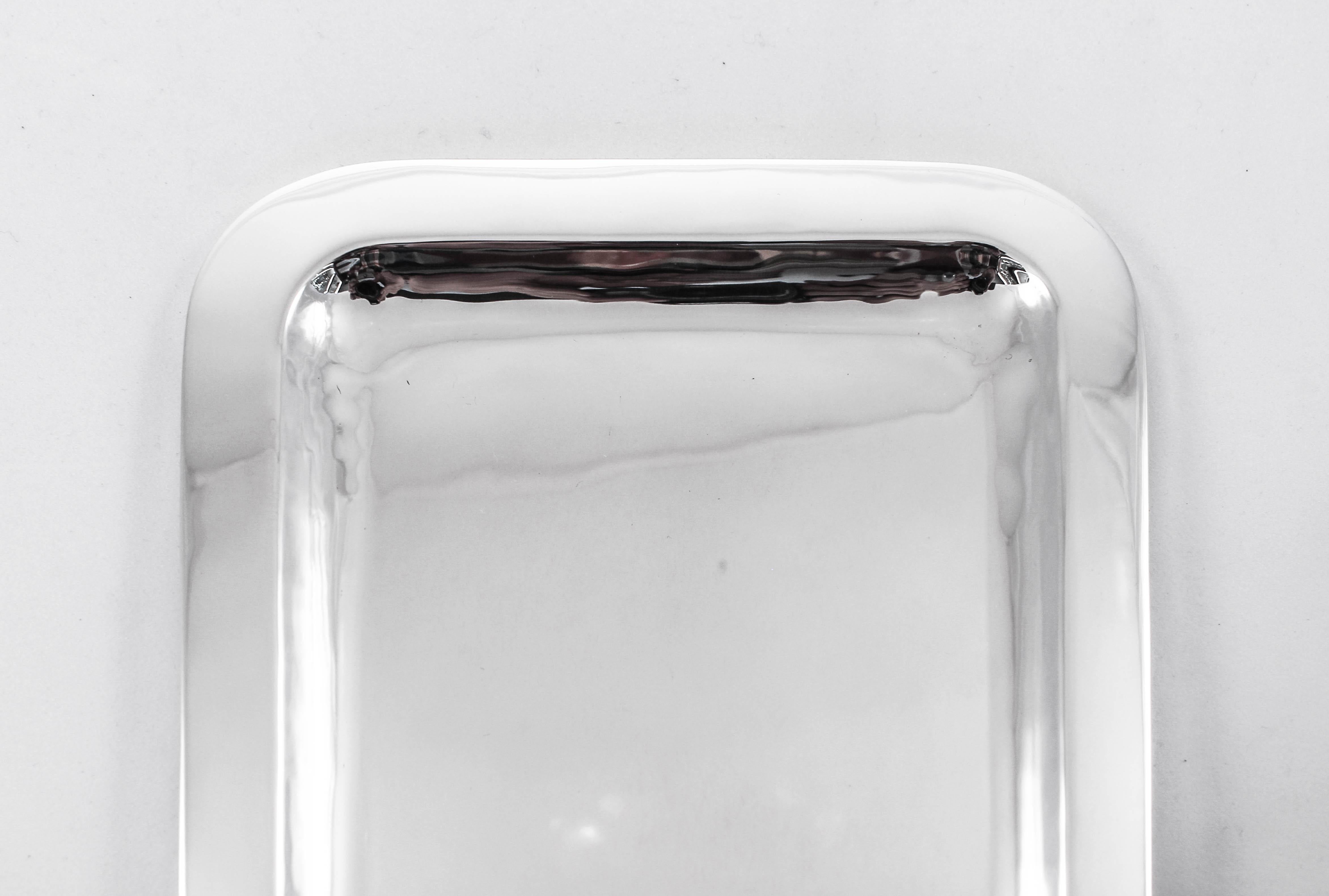 We are happy to offer this sterling silver tray for sale. The 1950s and 1960s were the height of the midcentury movement. An era that saw a resurgence of glamour and contemporary experimentation. This piece is sleek and modern; no etchings or any
