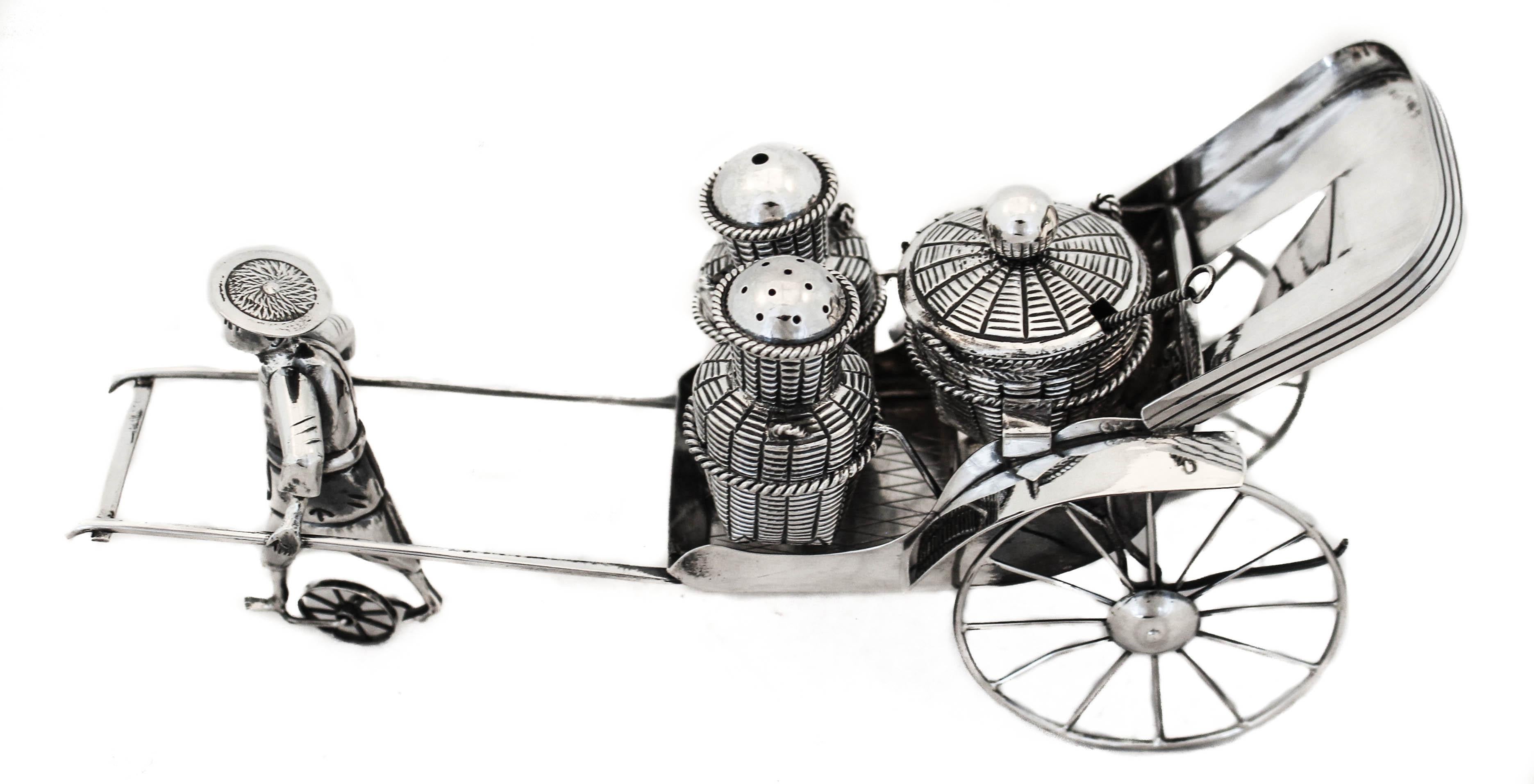 If you like the rare, unusual, whimsical continue reading…
We are happy to offer you this sterling silver antique Chinese salt & pepper shaker centerpiece designed as a man pulling a rickshaw. Manufactured by the Wang Hing Company of Hong Kong. The