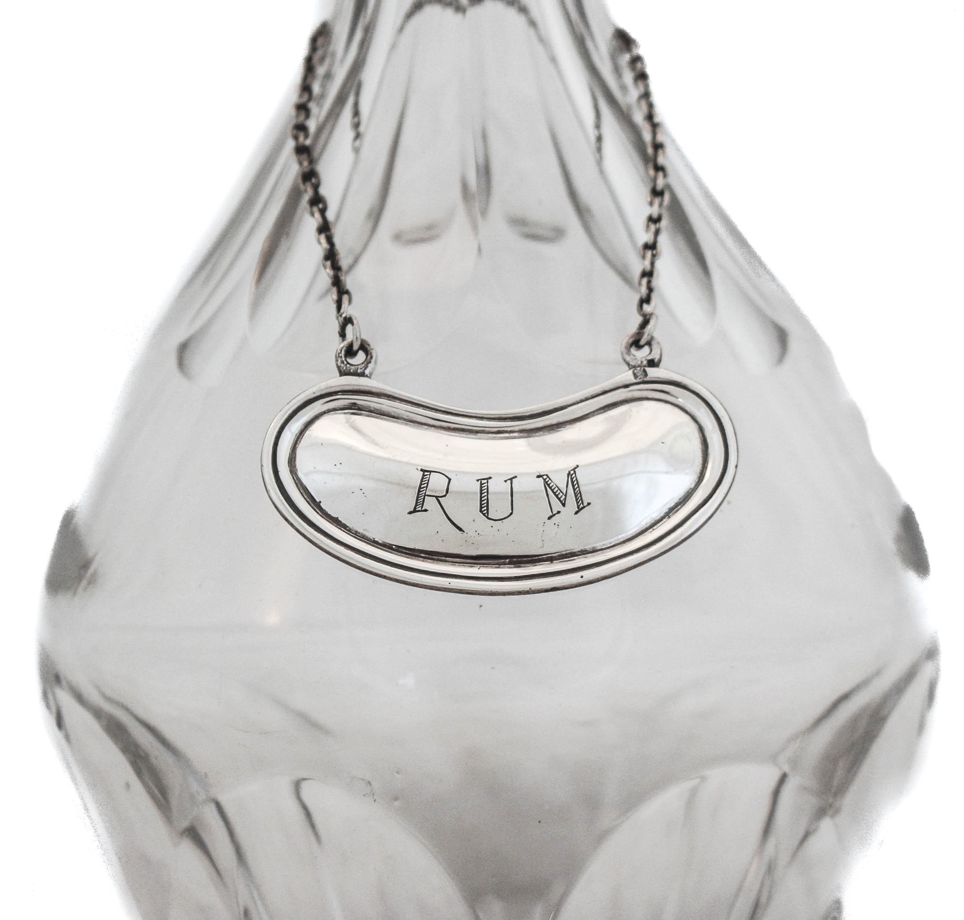 This liquor label is crafted of sterling silver, with the word 