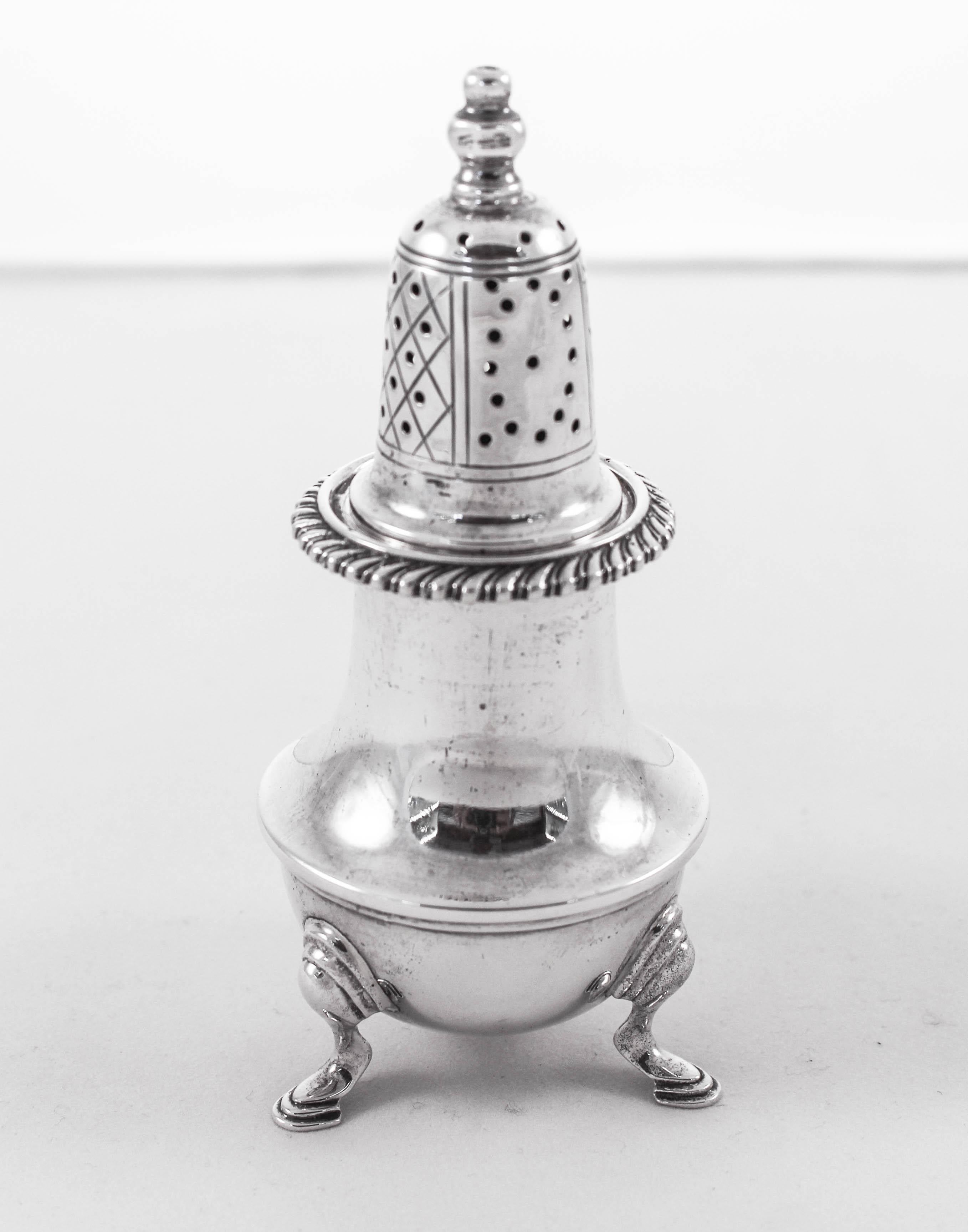 We proudly offer this sterling silver pair of salt and pepper shakers. Each stands on three legs raising it off the table. They have a wide bottom so that they can hold a large amount of salt/pepper. Around the neck a rope pattern wraps around. The
