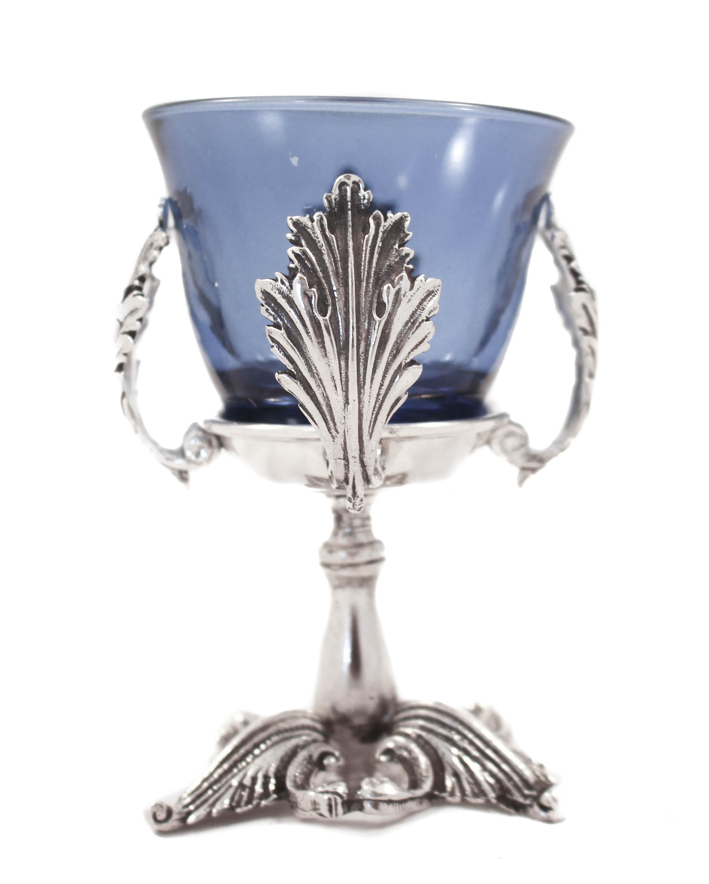 We are happy to offer you this sterling silver salt cellar. It has a blue glass liner and a sterling salt spoon. Propped on a Rococo style stand the glass is hugged by four leaves. It’s super easy to remove, wash and return after using. The spoon is