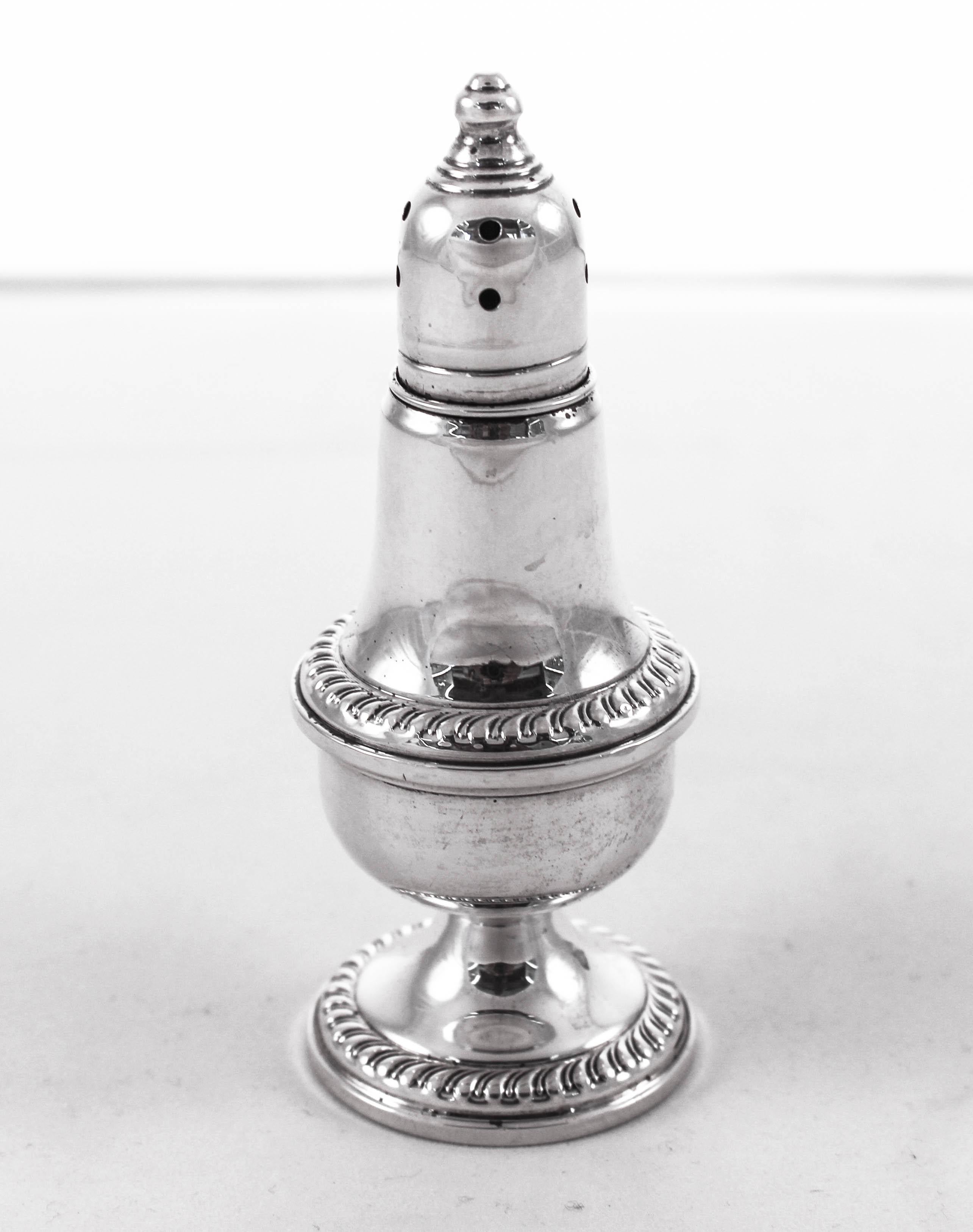 A pair of sterling silver salt and pepper shakers for sale. They have a decorative pattern around the base and mid-section. The tops unscrew for refill. They have a glass liner so you don’t need to empty them each week. The glass liners protect the