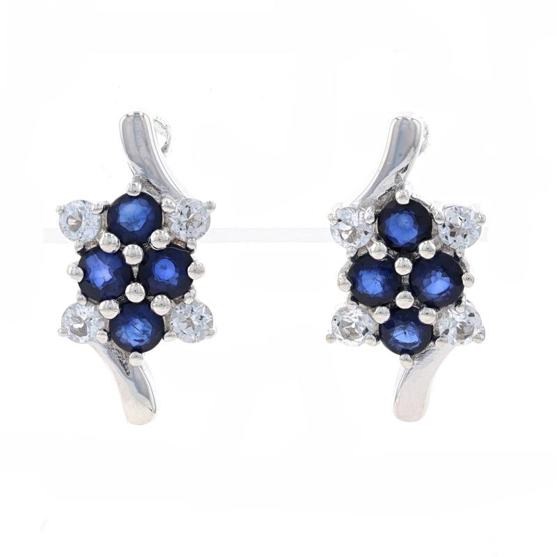 Metal Content: Sterling Silver

Stone Information
Natural Sapphires
Treatment: Beryllium Diffused
Cut: Round
Color: Blue

Natural White Topaz
Cut: Round

Style: Short Drop Bypass
Fastening Type: Butterfly Closures
Theme: Floral