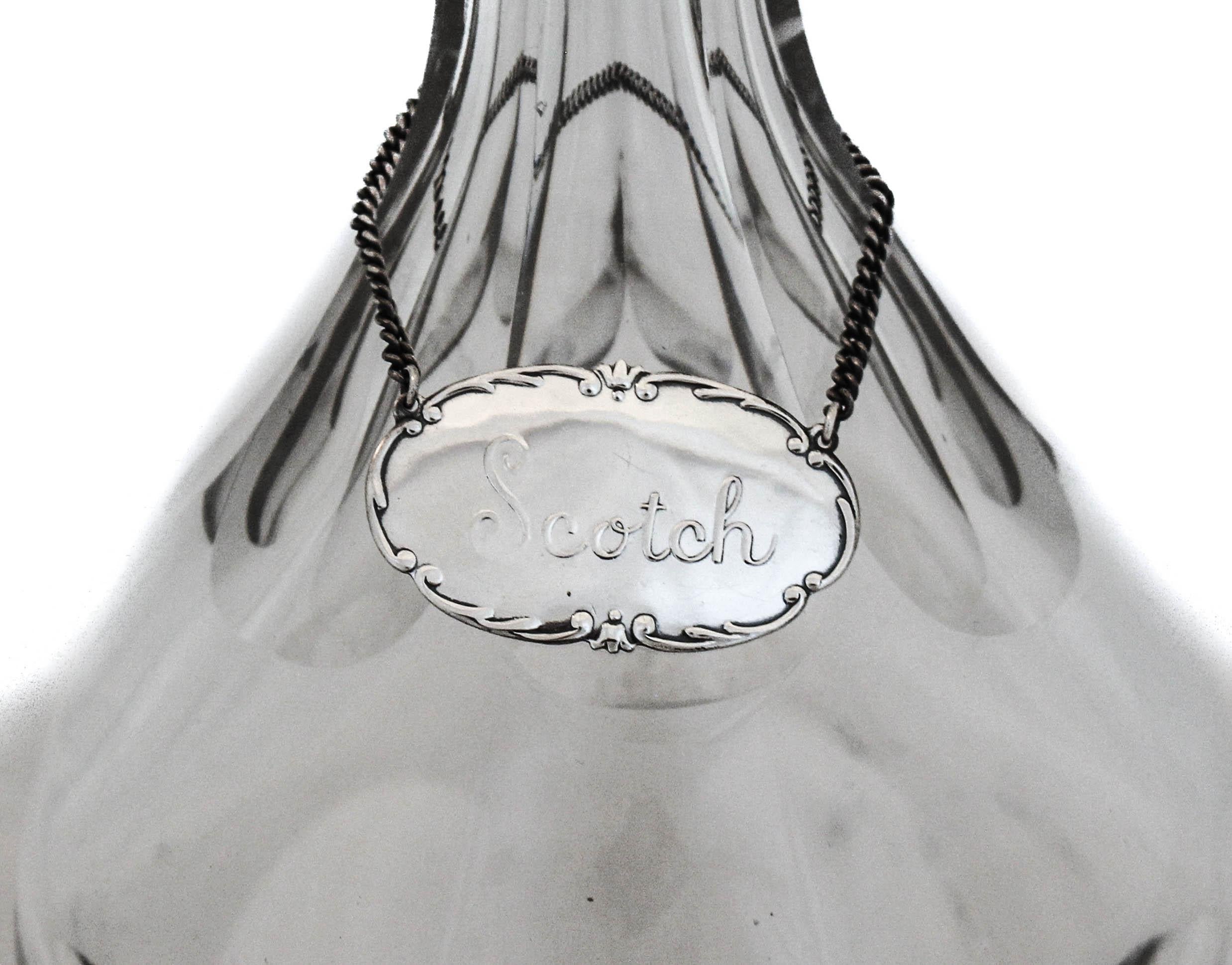 This liquor label is crafted of sterling silver, with the word 
