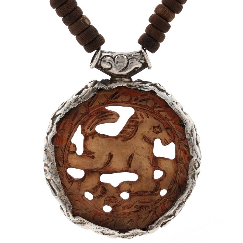 Contenuto del metallo: Argento Sterling

Informazioni su A. Stone
Serpentino Nature
Taglio: Scolpito
Colore: Marrone (medaglione) & Verde giallastro (perline)

Informazioni sul materiale
Legno
Taglio: Perlina
Colore: marrone

Stile della collana: