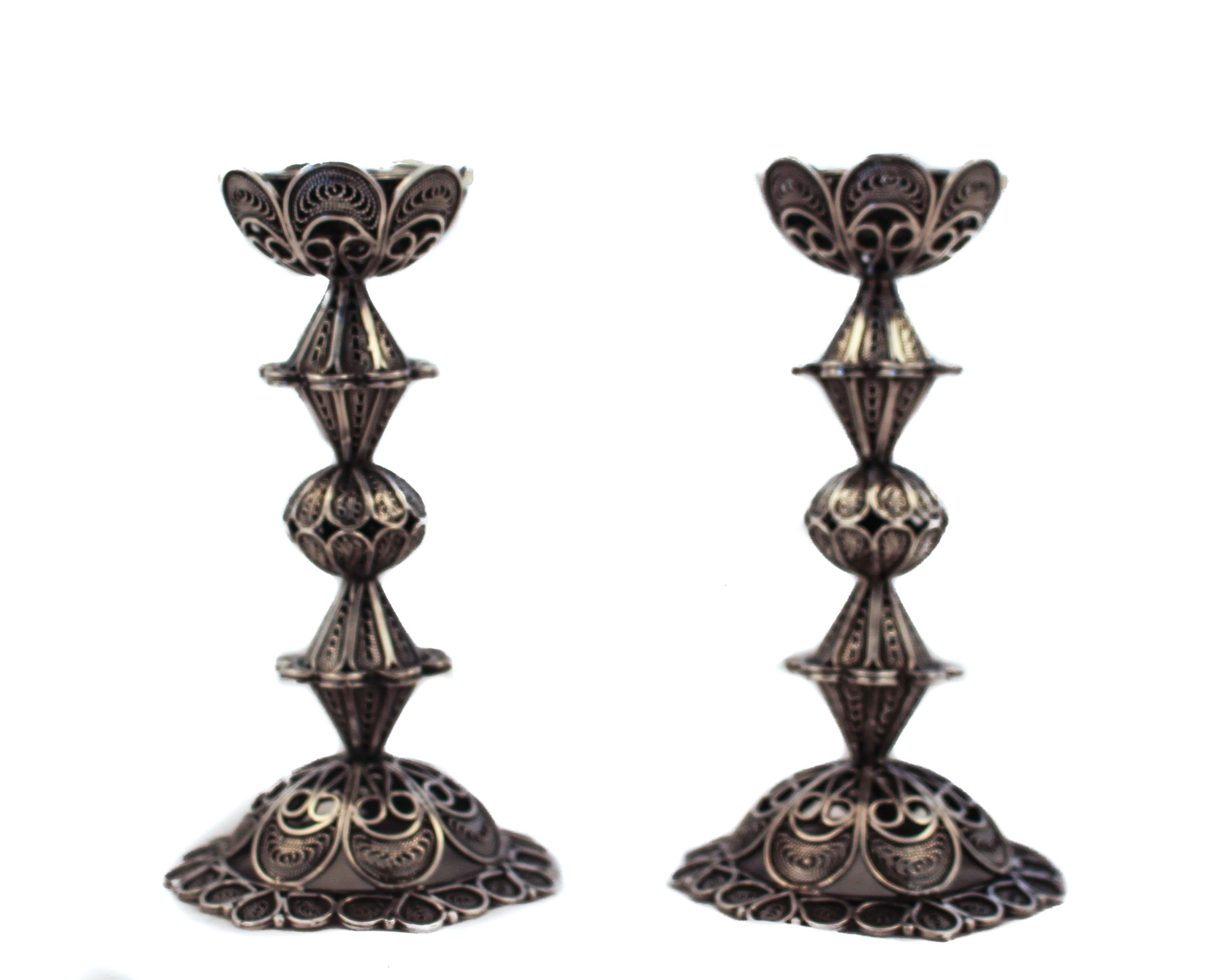 Being offered is a pair of sterling silver candlesticks and a matching charity (Tzedakah) box. Handmade in a filigree design, the invoke the craftsmanship of Israeli artisans and the world renowned Betzalel School of Art in Jerusalem. The
