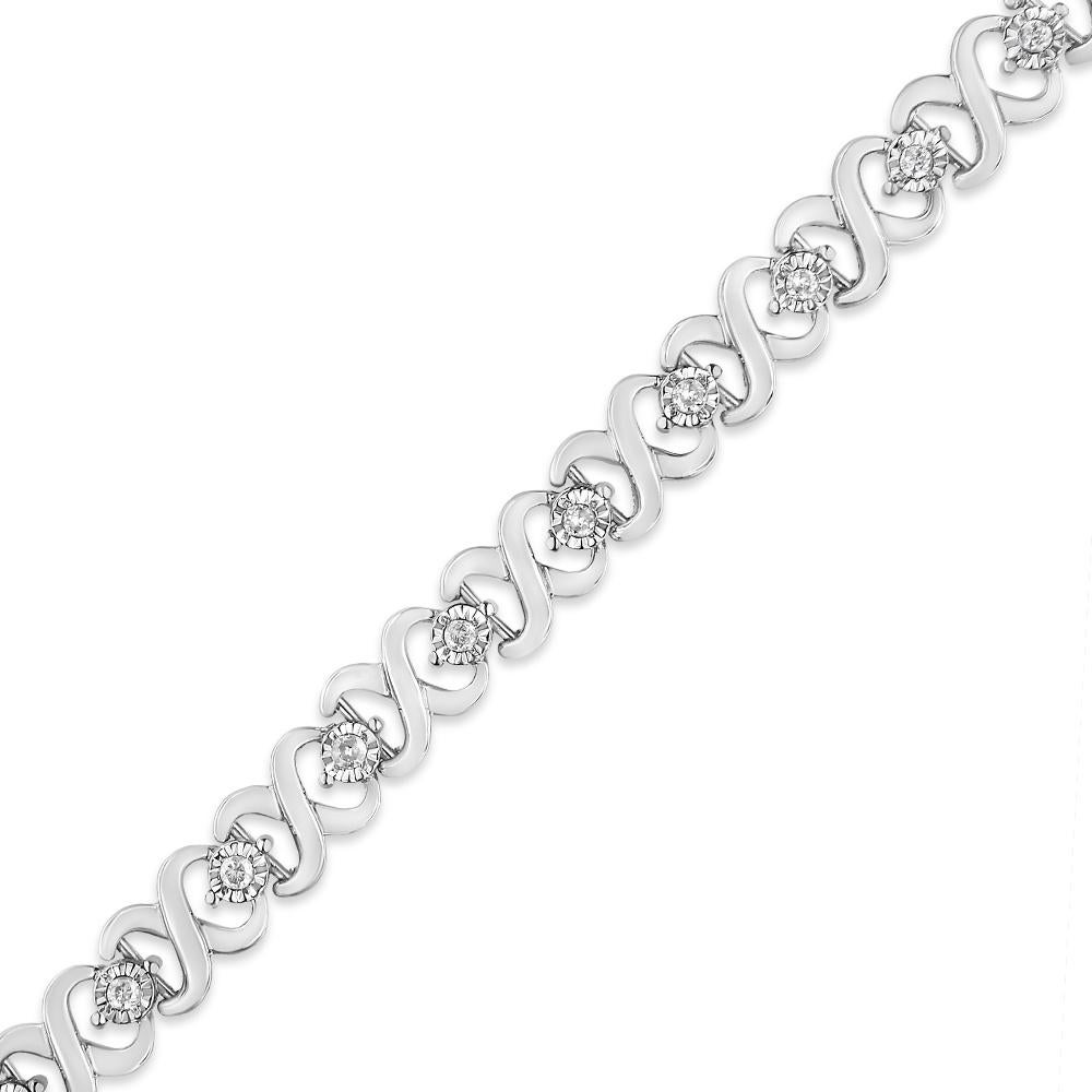 Dress up your everyday look with this classic infinity link diamond tennis bracelet. This piece is crafted from .925 sterling silver, a metal that will stay tarnish free for years to come. Boasting a design of silver 
