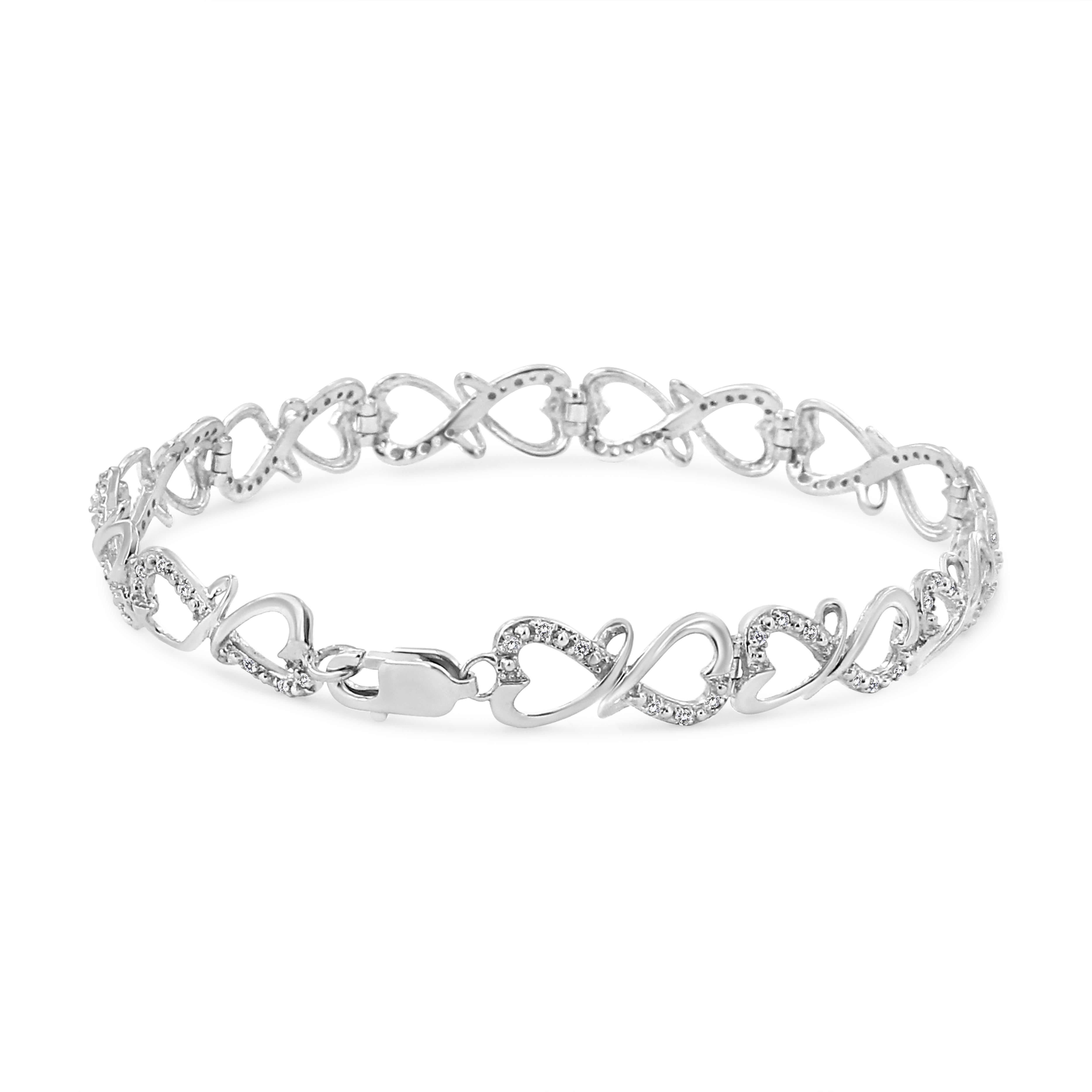 Modern and chic, this beautiful silver bracelet is elegantly crafted with a double heart link design. The metal is genuine .925 sterling silver, ensuring it will stay tarnish free for years to come. The double heart links are intricately embellished