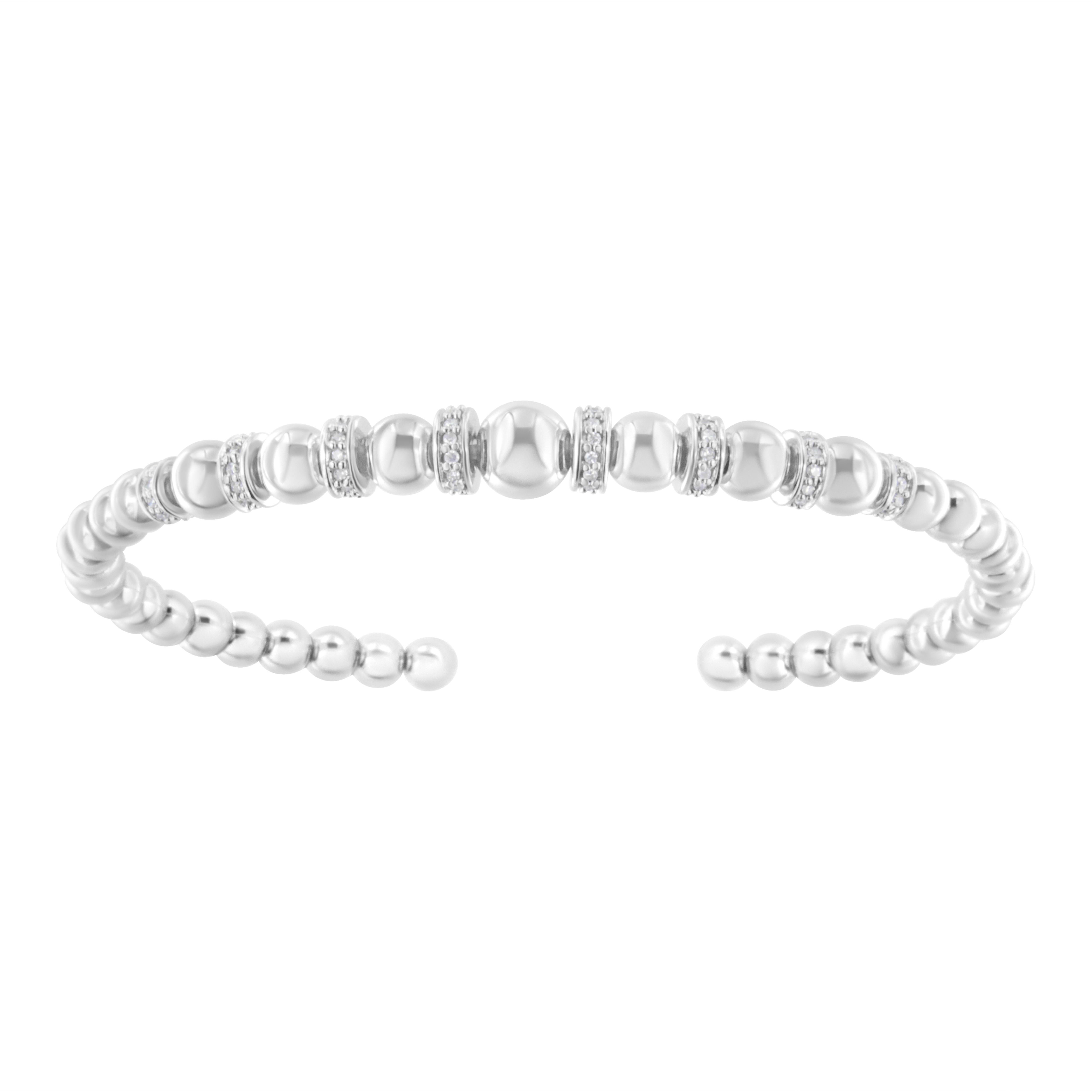 This gorgeous .925 sterling silver cuff bangle bracelet features 0.25 carat total weight of round, brilliant cut diamonds with 90 stones in all. The bangle features sterling silver rondelle beads that are largest in the center and become smaller
