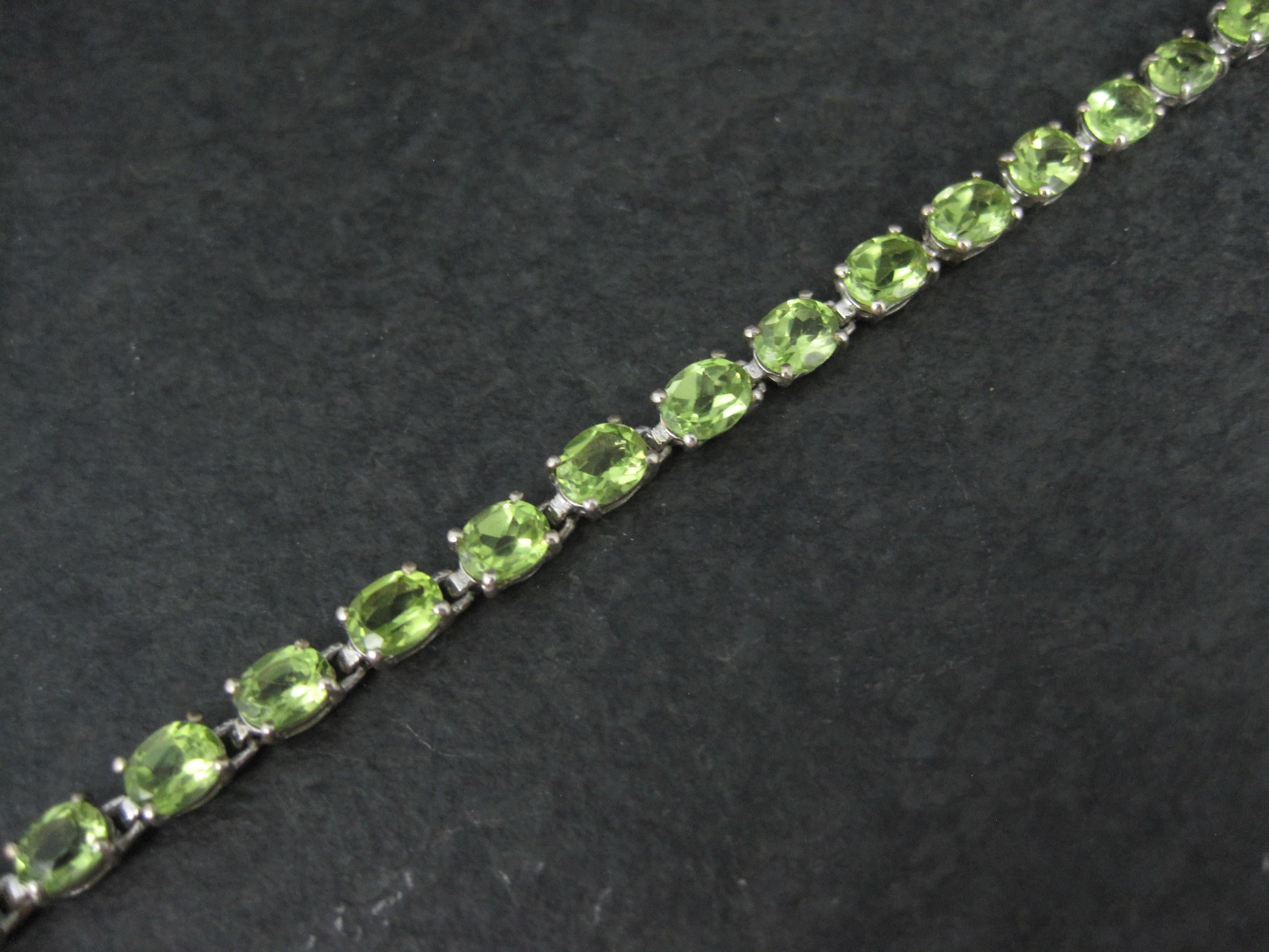 This beautiful bracelet is sterling silver.
It features 28 oval cut 4x6mm peridot gemstones at an estimated 11.50 total carats.
Measurements: 3/16 of an inch wide, 7 1/2 wearable inches
Marks: 925
Weight: 6.6 grams
New old stock

