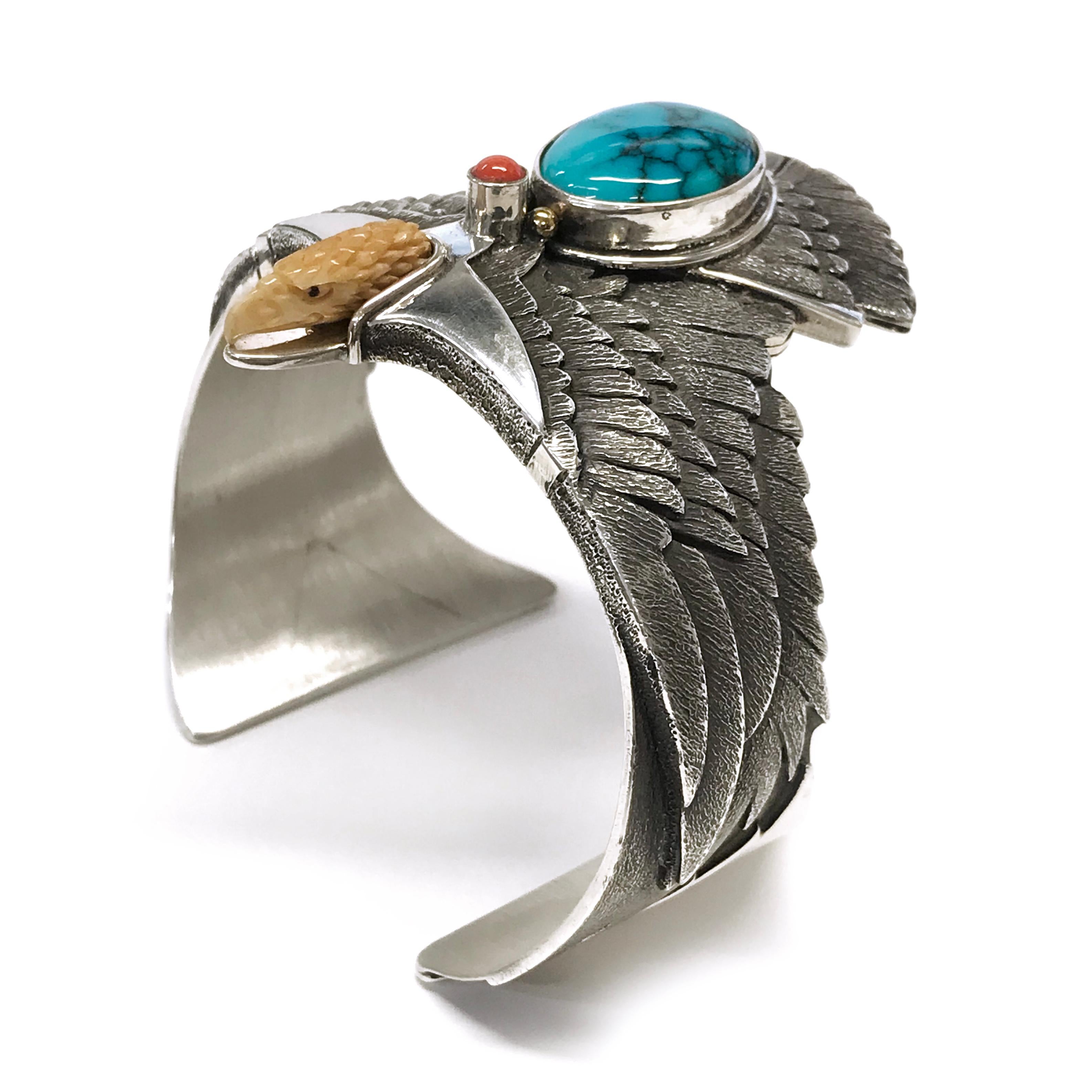 Handcrafted from a sheet of Sterling Silver with 14k accents by jewelry maker, Ray Winner. This phenomenal cuff bracelet features a natural Kingman Turquoise pear-shaped cabochon and bezel-set Mediterranean Coral round cabochon. The form of the cuff