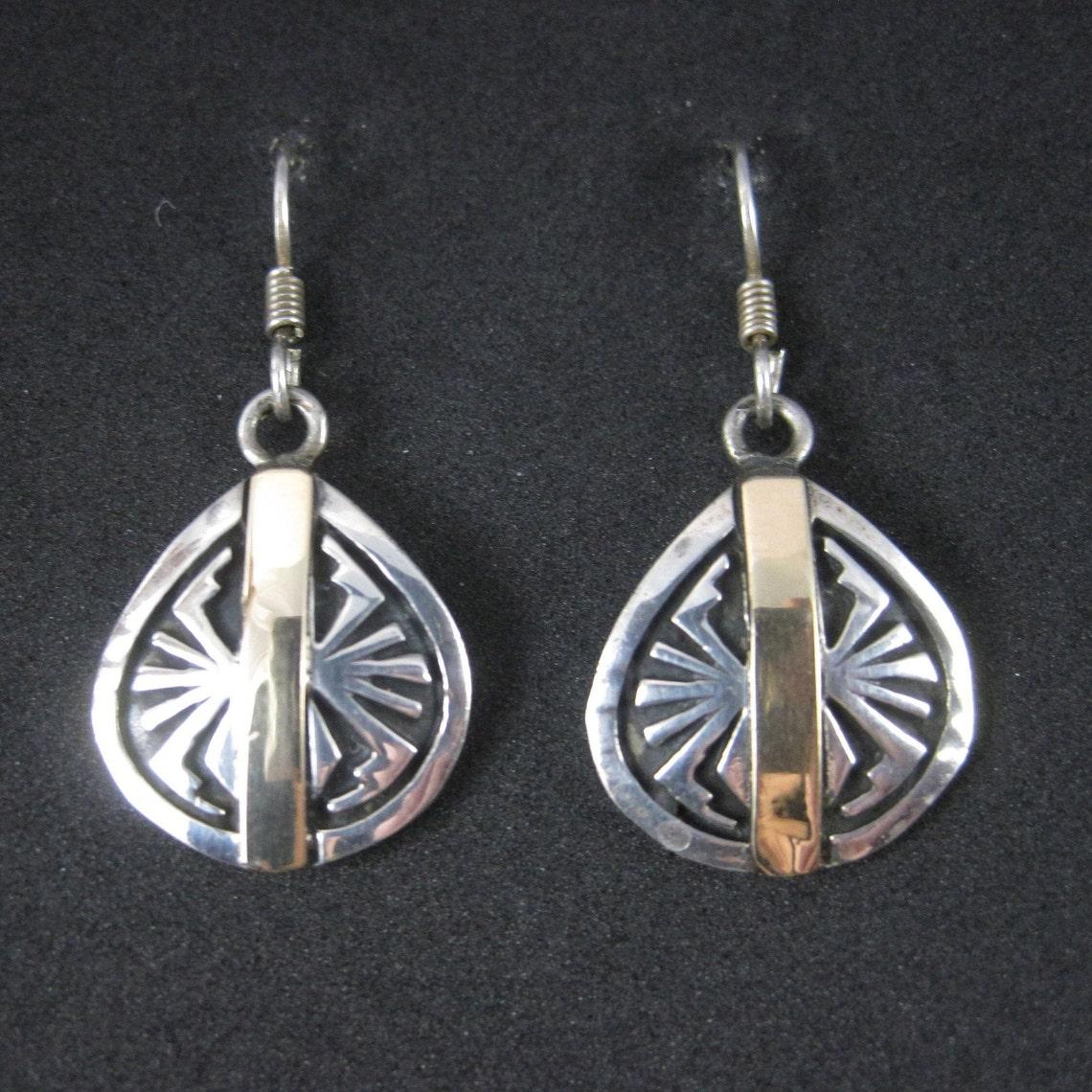 These beautiful vintage Southwestern spider earrings are sterling silver and 14k yellow gold.

Measurements: 5/8 by 1 5/16 inches from the top of the earwire
Weight: 6.1 grams

Marks: Sterling, 14K

Condition: Excellent

Earrings have been steam