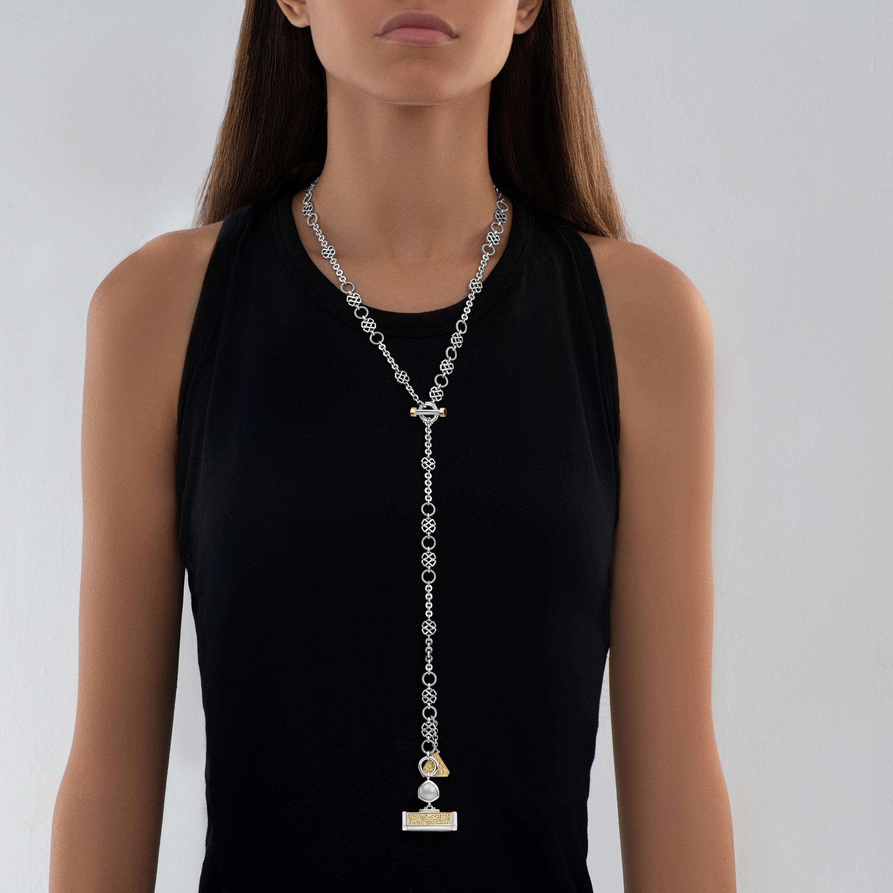 Sterling Silver and 18 Karat Gold Necklace that can be adjusted to be worn as a Long Necklace or in a Lariat-style. Adorned with Garnets and Cultured Pearls, the Necklace features Azza Fahmy's signature Arabic Calligraphy and T-Lock