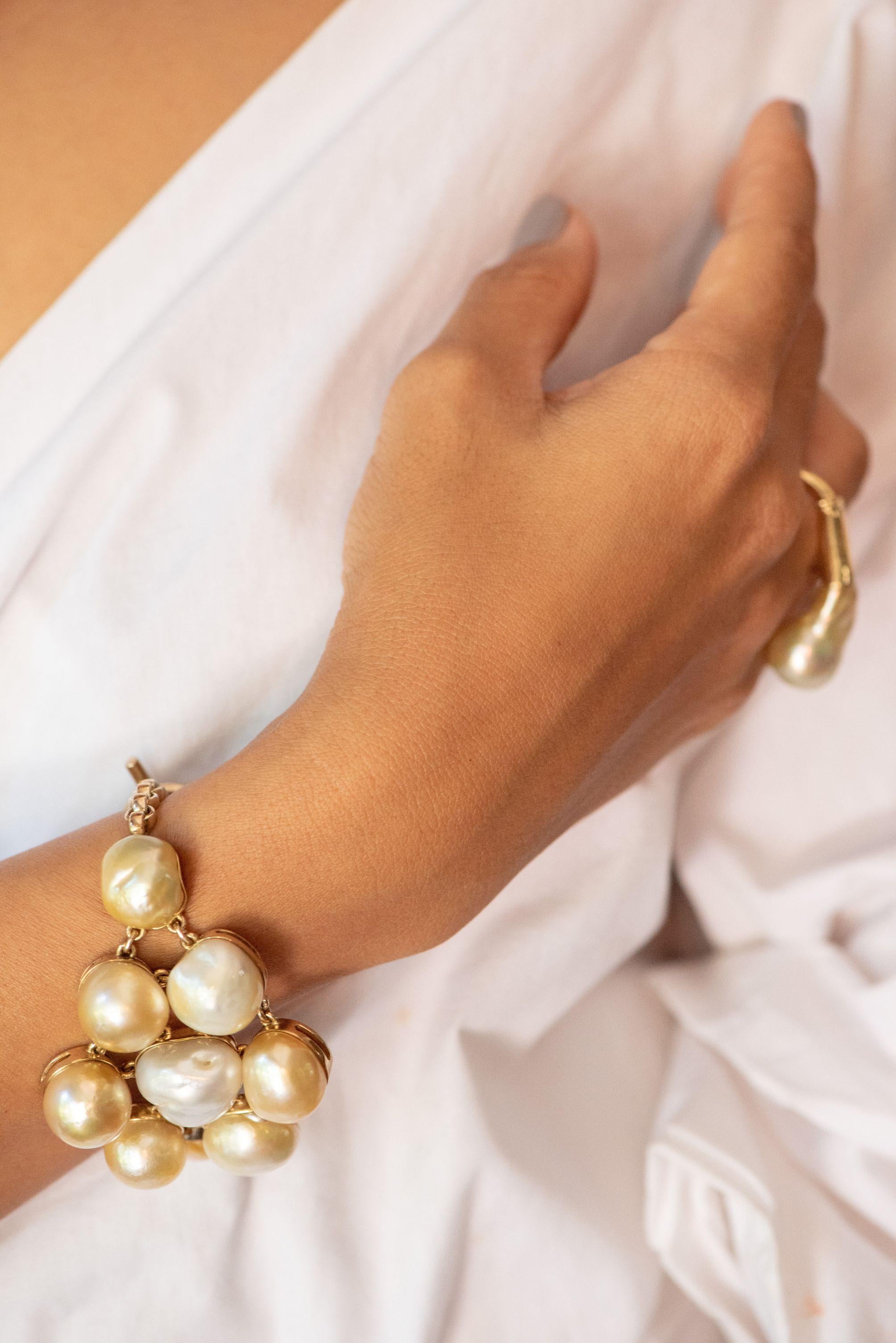 Nine iridescent gold and cream baroque south sea pearls nestled in a sterling silver and 18 karat gold plated bracelet will elevate any look. The bracelet is 19 by 5.5 cm, and the pearls a generous 14 to 17mm.