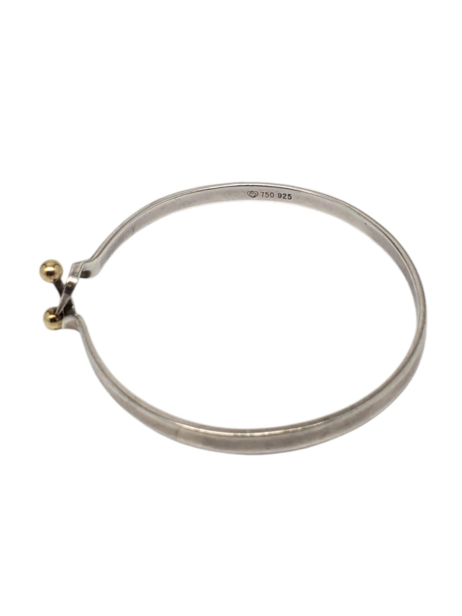Sterling Silver & 18k Hook Bangle Bracelet-

This vintage Tiffany inspired hook bangle bracelet in sterling silver with 18k gold plated balls.

Size: fits up to 8