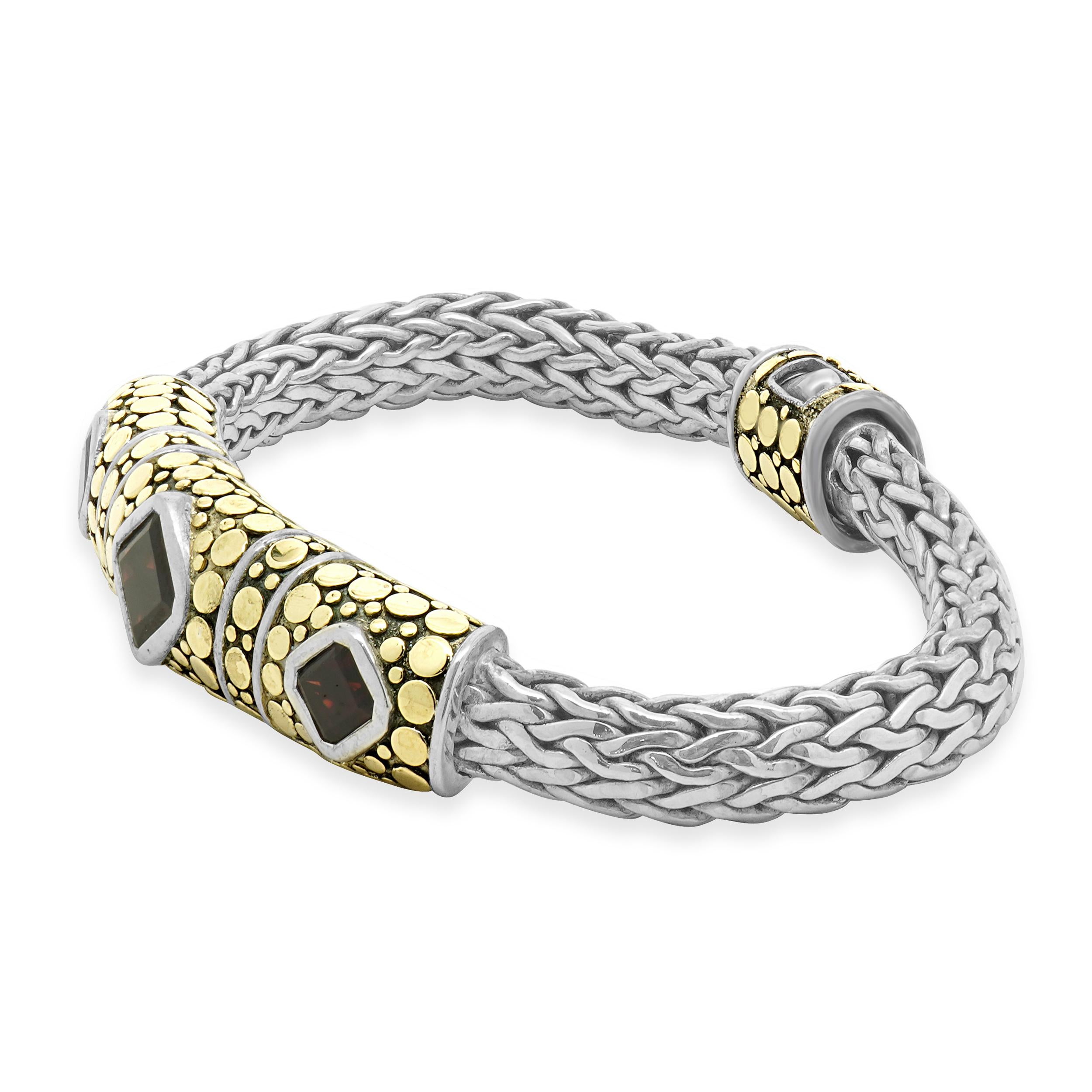 Designer: John Hardy
Material: Sterling silver & 18K yellow gold
Garnet: 3 square cut = 5.00cttw
Dimensions: bracelet will fit up to a 6.5-inch wrist
Weight: 51.66 grams