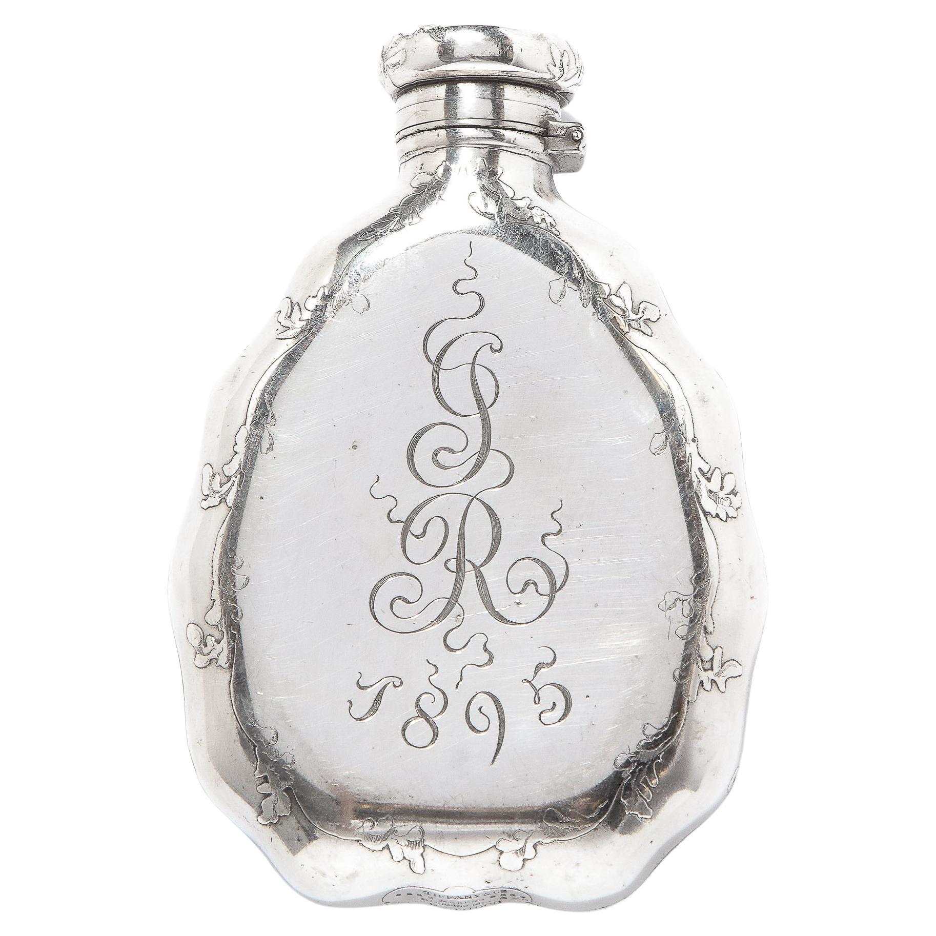 Sterling Silver 19th Century Tiffany & Co. Nautical Flask. Depicting a sail boat at sea with a nautical frame of shells and foliate design. Most surely from the America's Cup. With a monogram of GR and date of 1895 verso. Signed to underside